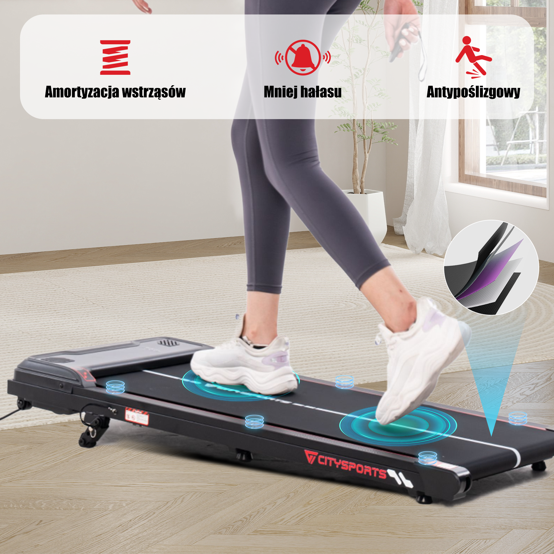 Osoba spaceruje po czarnej bieżni. Etykiety tekstowe podkreślają funkcje, takie jak antypoślizgowość i amortyzacja.