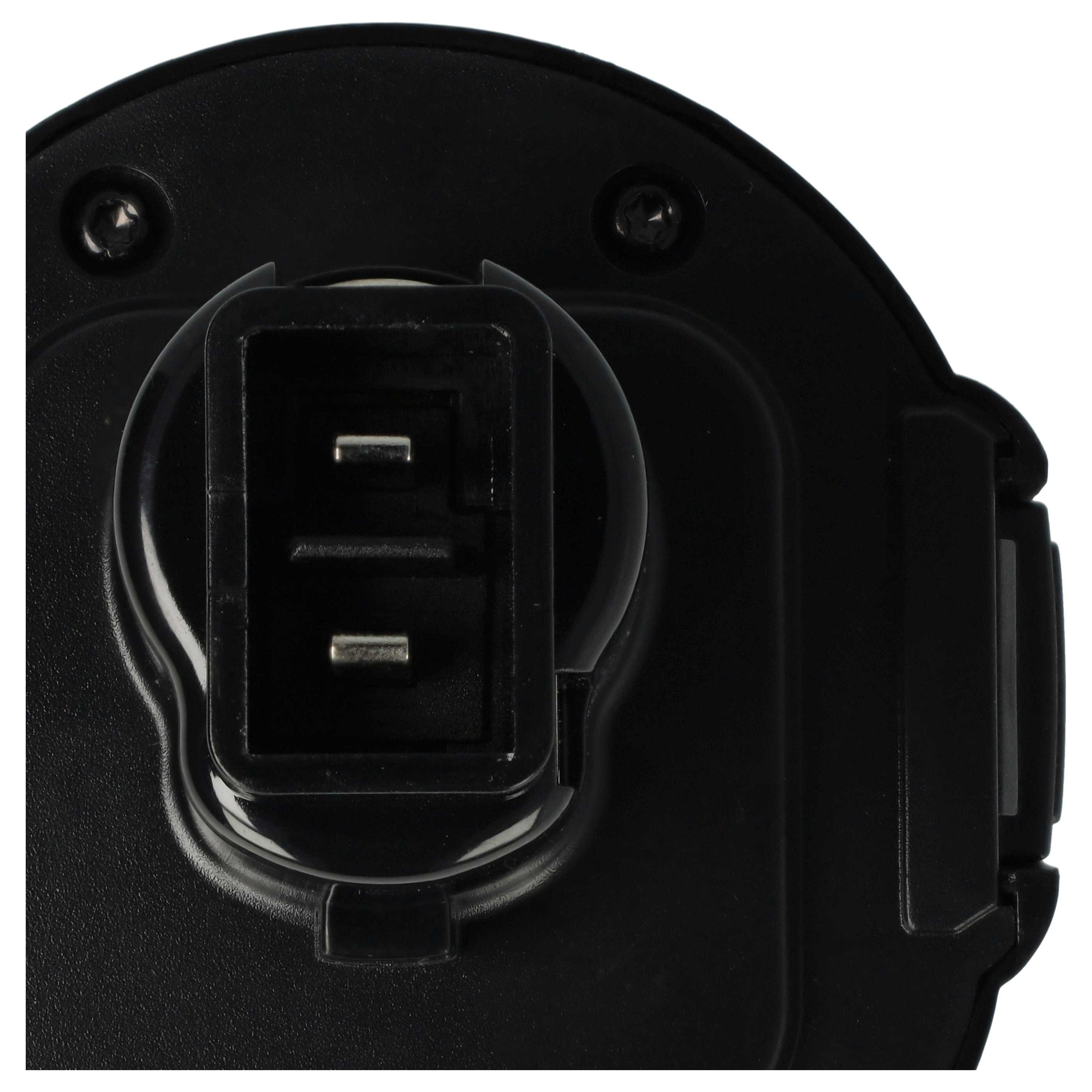 Nahaufnahme einer schwarzen elektrischen Komponente mit rechteckigem Stecker. Zwei Metallstifte sind sichtbar.