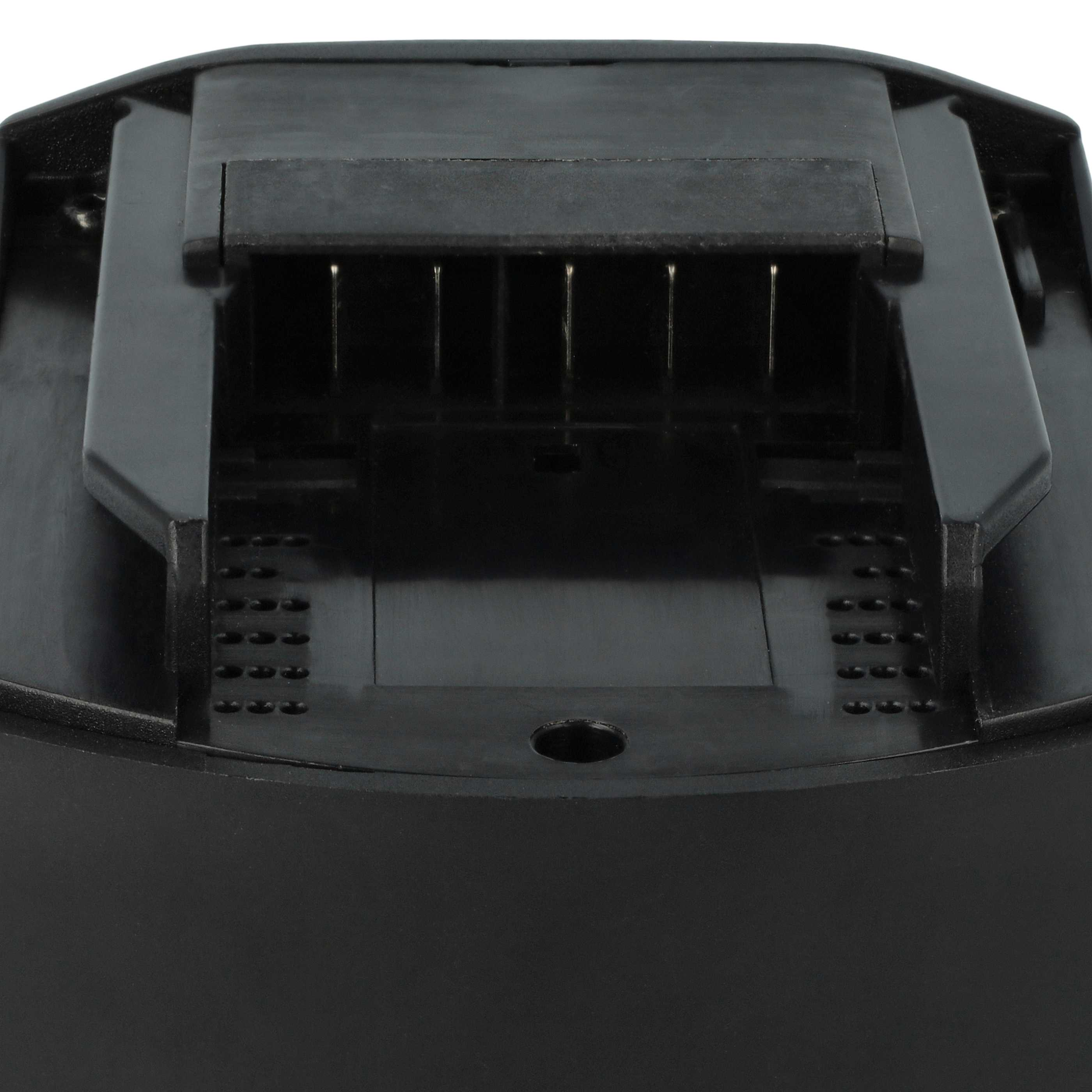 Nahaufnahme einer schwarzen Batteriebasis mit metallischen Stiften und mehreren kleinen Löchern.