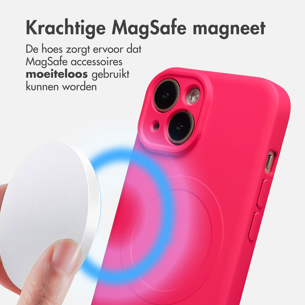 A hand holds a white MagSafe charger near a pink phone case. Blue magnetic field lines are shown around the case.
