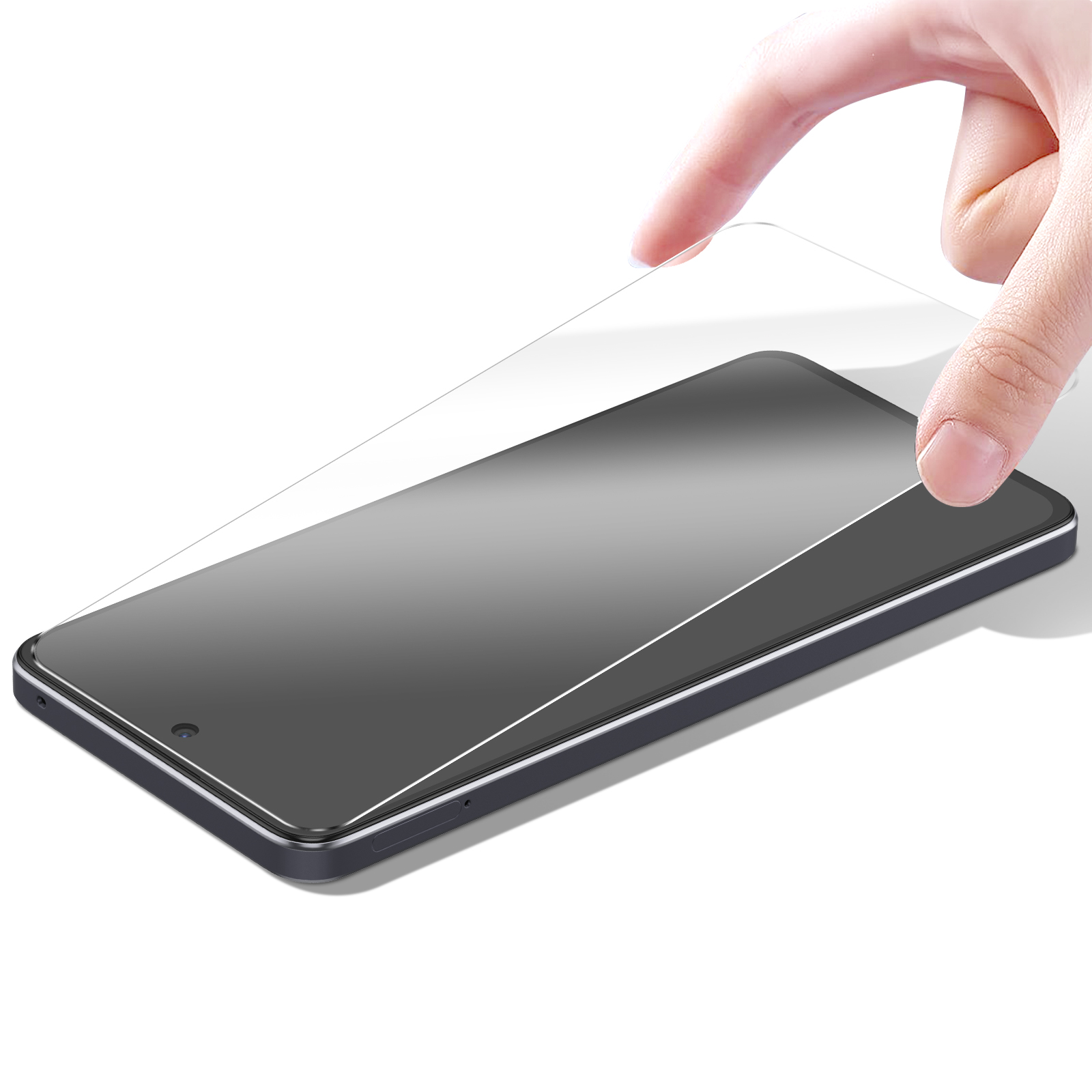 Una mano tiene una protezione schermo trasparente sopra uno smartphone nero. Il telefono è su una superficie bianca.