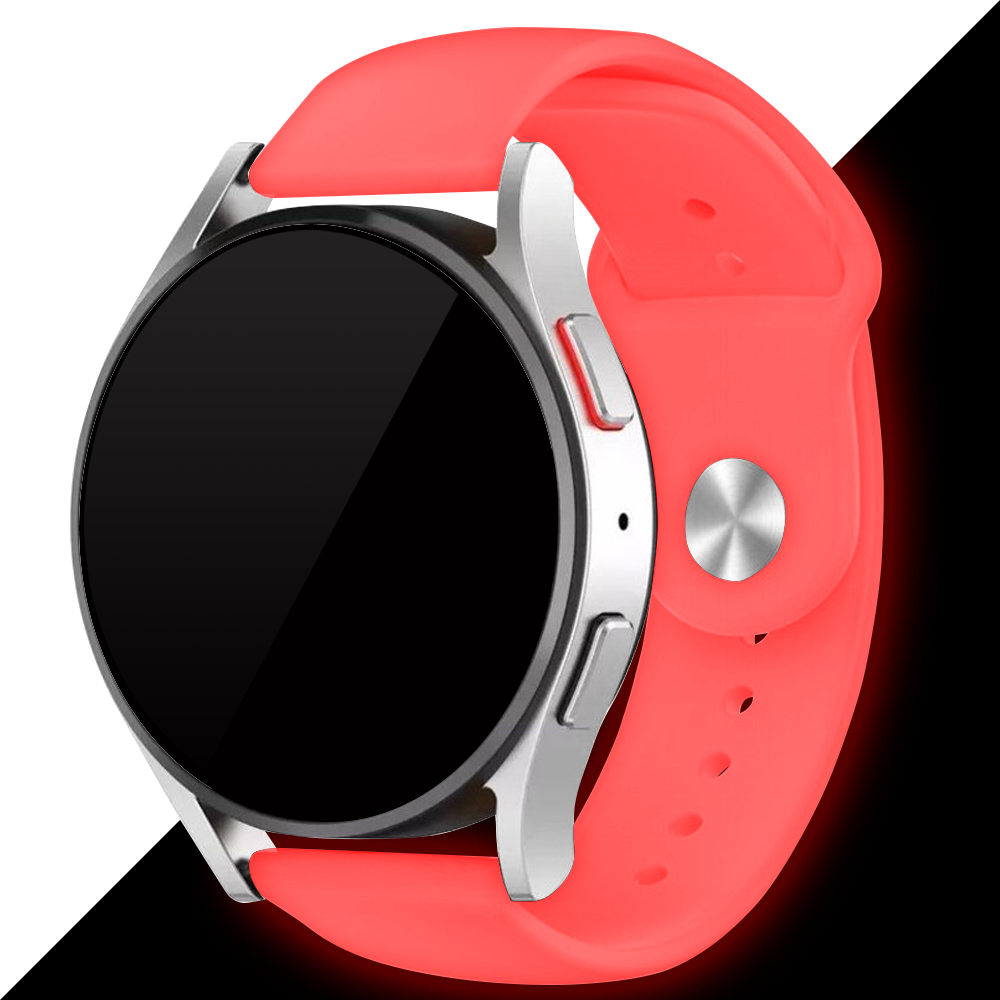 Eine silberne Smartwatch mit schwarzem Bildschirm und korallenfarbenem Armband. Die Uhr befindet sich auf einem schwarz-weißen Farbverlaufshintergrund.