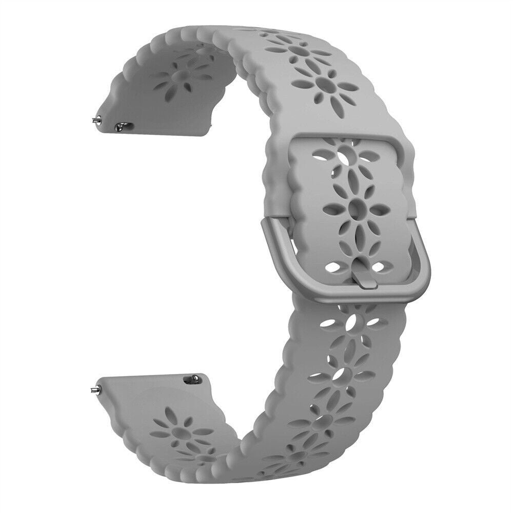 Ein hellgraues Uhrenarmband mit floralen Ausschnitten. Das Band ist gebogen und zeigt die Schnalle und die Befestigungspunkte.