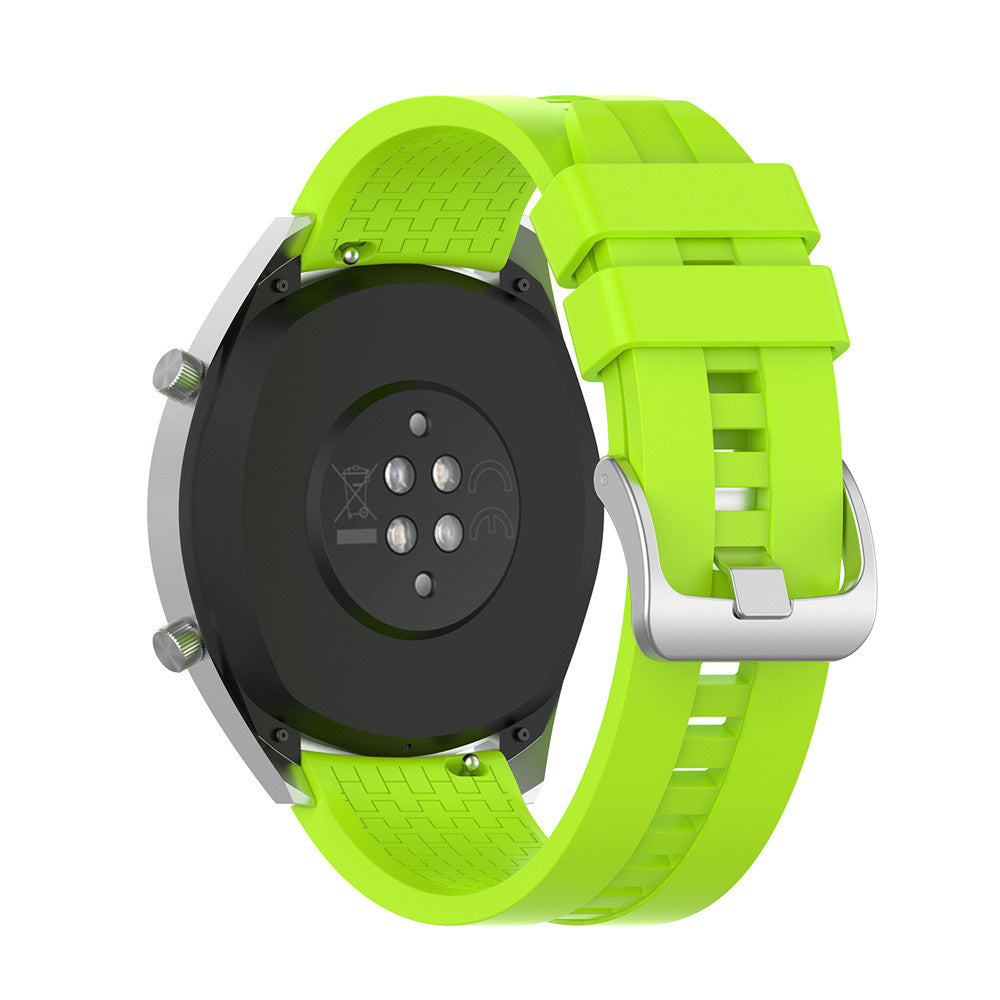 Nahaufnahme einer Smartwatch. Die Uhr ist lindgrün mit einem silbernen Metallrahmen. Die Rückseite ist schwarz und hat Sensoren.