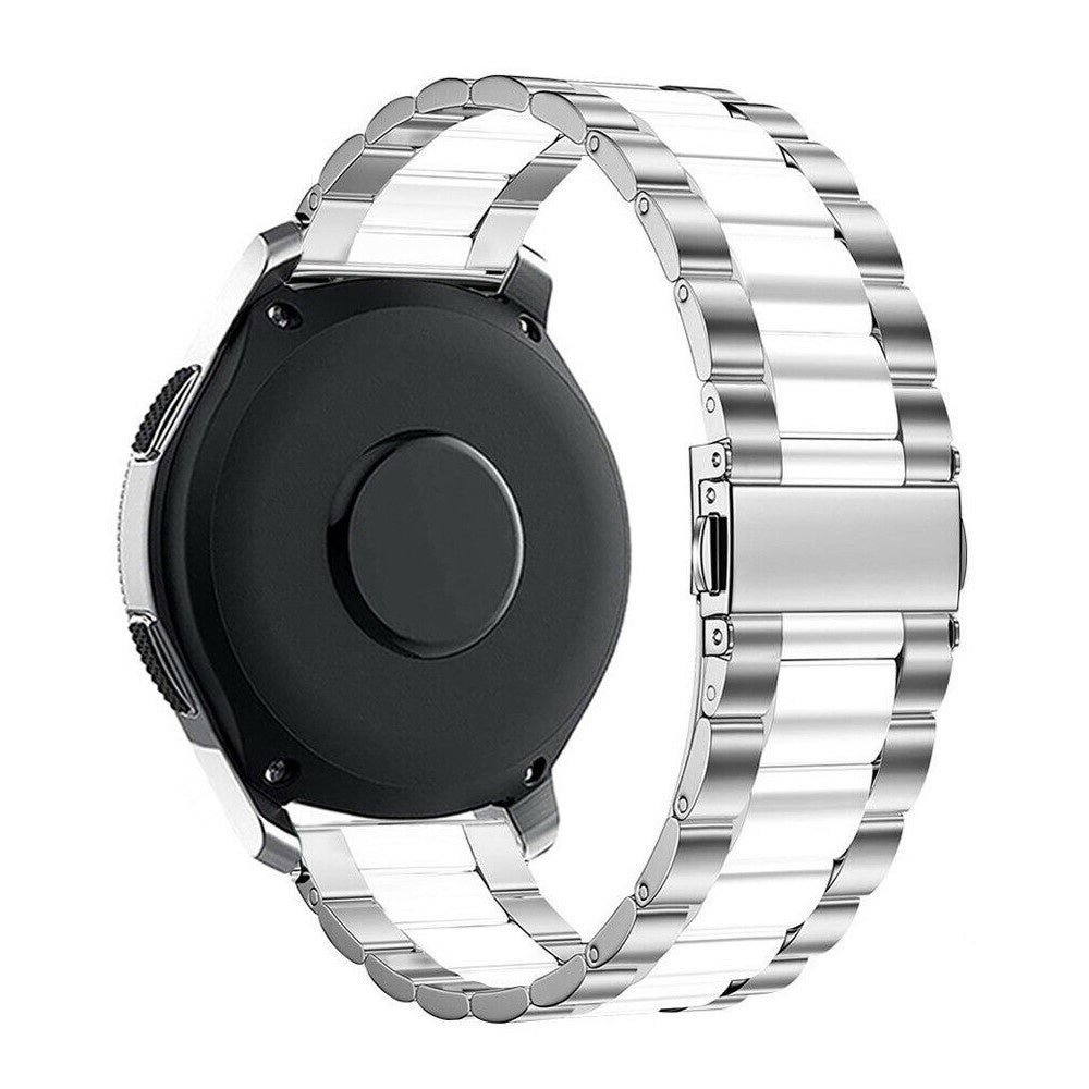Eine schwarze Smartwatch mit einem silbernen und weißen Metallband. Das Band ist teilweise abgenommen.
