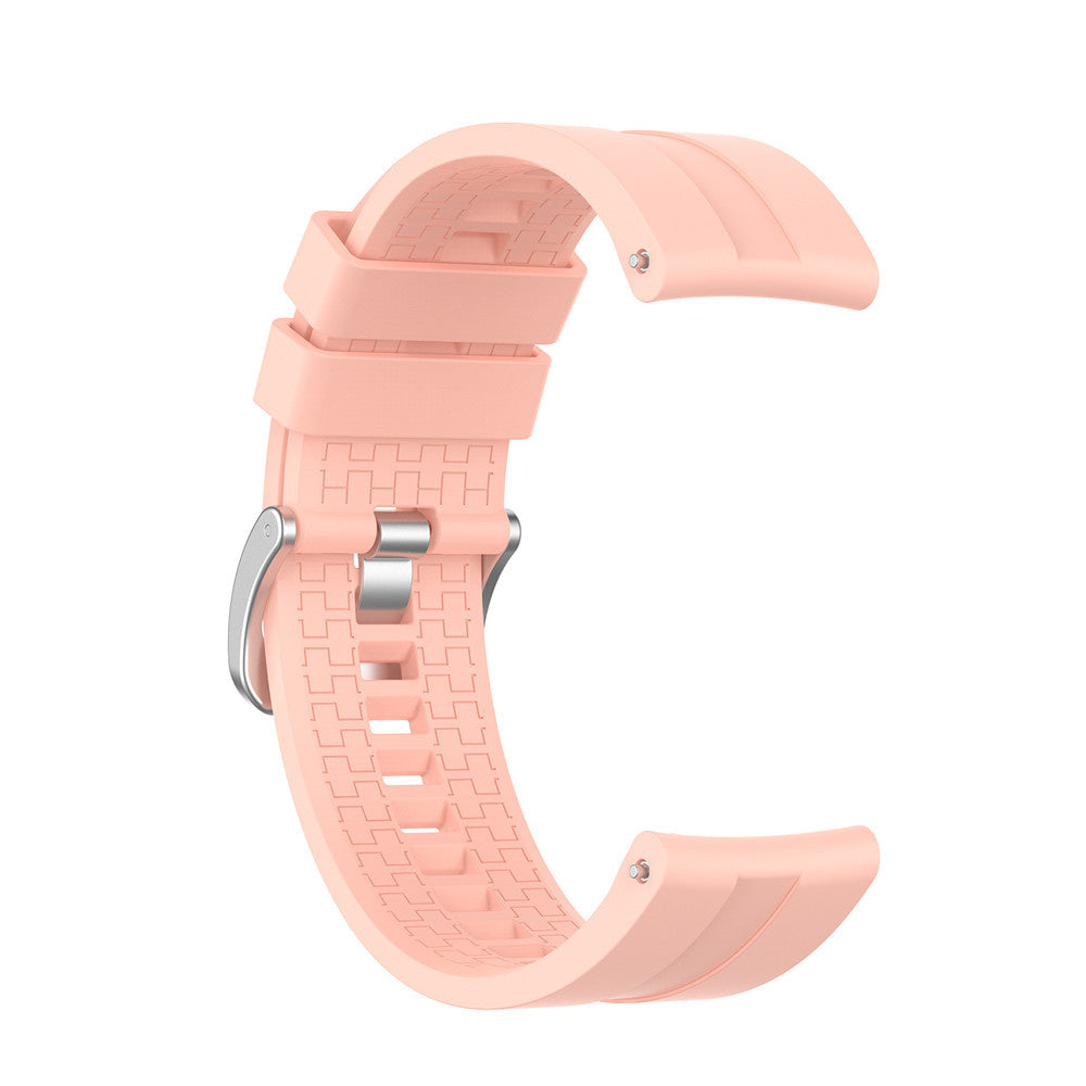 Ein hellrosa Armband ist vor weißem Hintergrund gebogen. Das Armband hat eine Metallschnalle und eine strukturierte Textur.