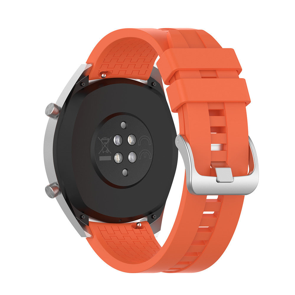 Eine orangefarbene Smartwatch mit schwarzer Rückseite und silbernen Knöpfen. Das Armband ist orangefarben mit einer silbernen Schließe.