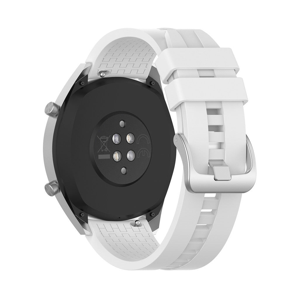 Weiße Smartwatch mit schwarzer Rückseite. Die Uhr hat ein weißes Armband und eine silberne Schnalle. Die Rückseite zeigt Sensoren und Symbole.