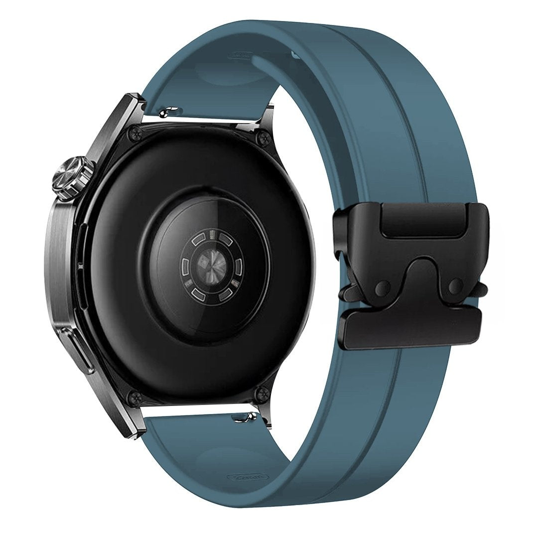 Eine Smartwatch mit schwarzem Zifferblatt und teal-farbenem Armband. Das Armband wird mit einer schwarzen Schnalle befestigt. Die Uhr ist silberfarben.