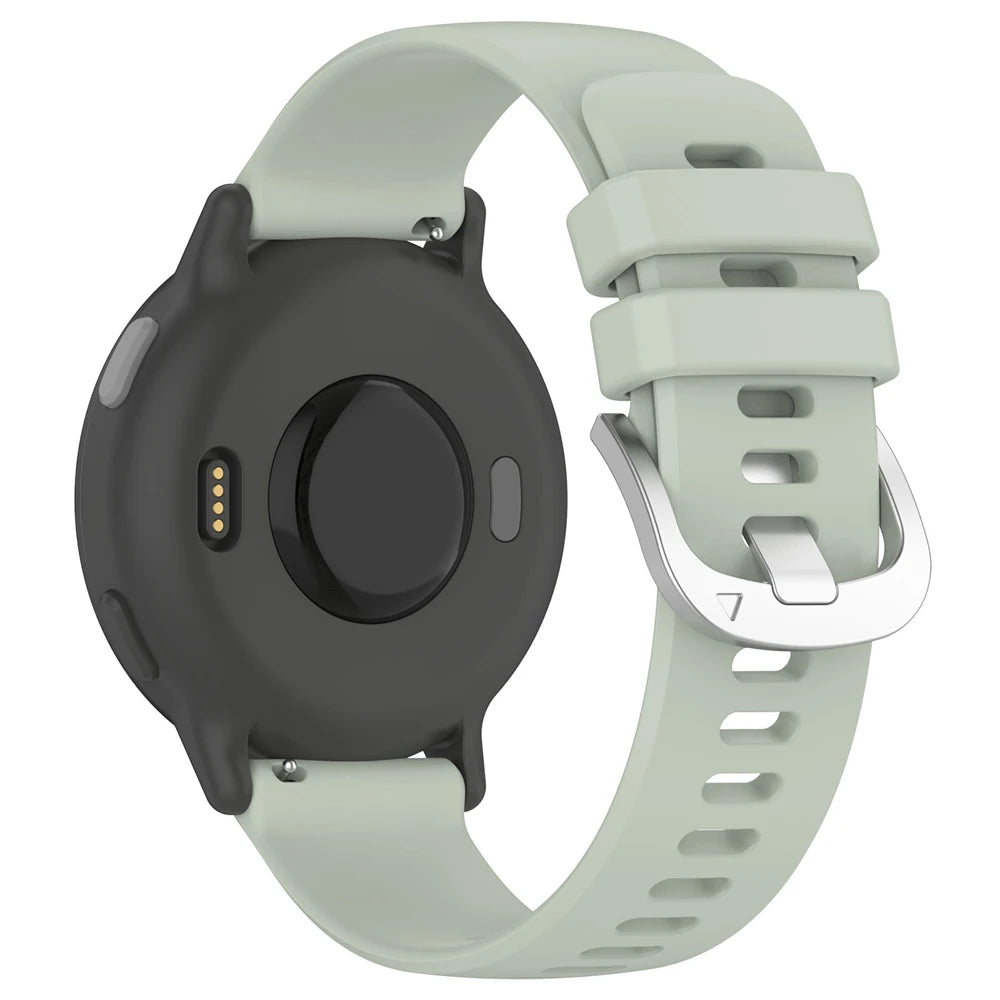 Eine Smartwatch mit schwarzem Gehäuse und hellgrünem Armband. Die Rückseite zeigt Sensoren, das Armband hat eine Metallschnalle.