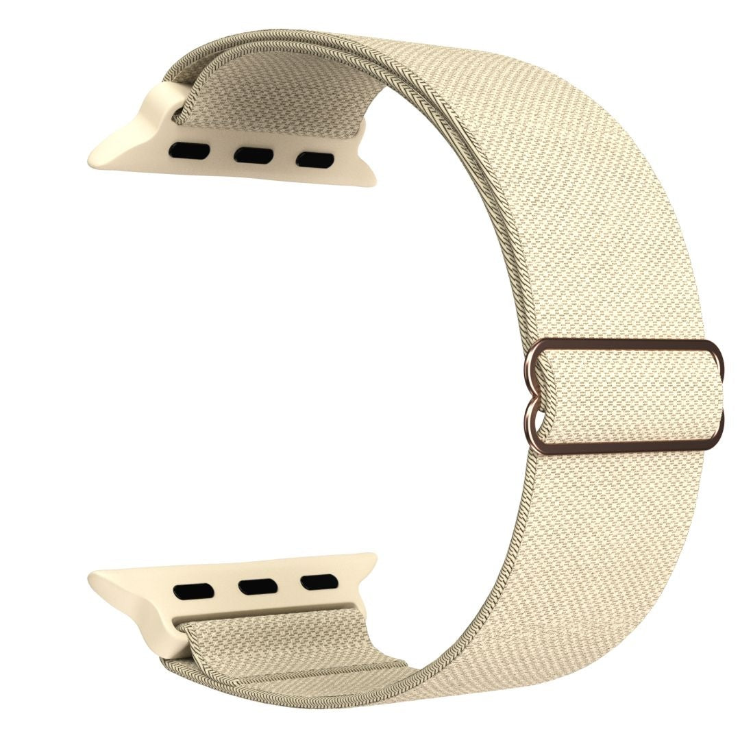 Ein beiges Apple Watch-Armband mit cremefarbenen Anschlüssen und einer braunen Metallschnalle. Das Band besteht aus gewebtem Stoff.