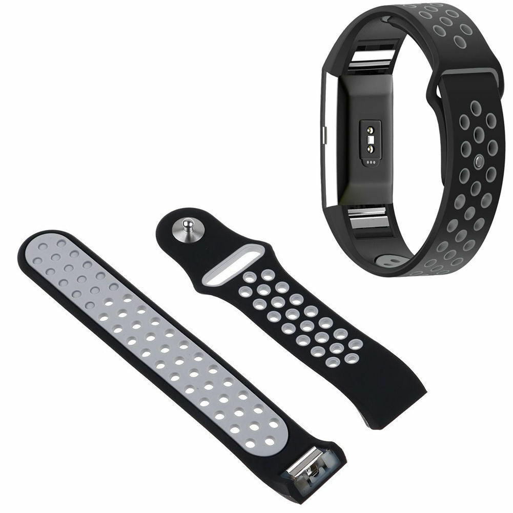 Ein schwarzes Smartwatch-Armband und zwei zusätzliche Armbänder. Die Bänder haben perforierte Löcher und ein graues Innere.
