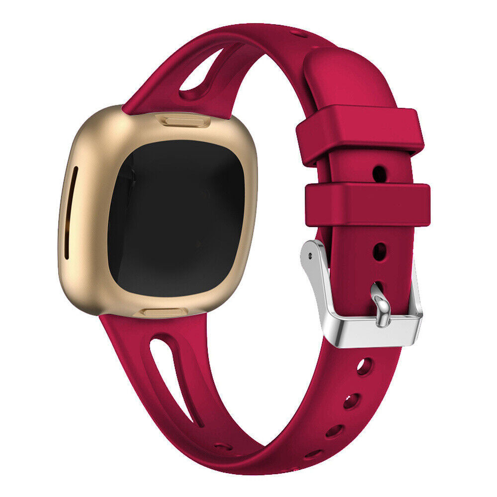 Eine goldene Smartwatch mit schwarzem Bildschirm und rotem Armband. Das Armband hat eine silberne Schnalle.