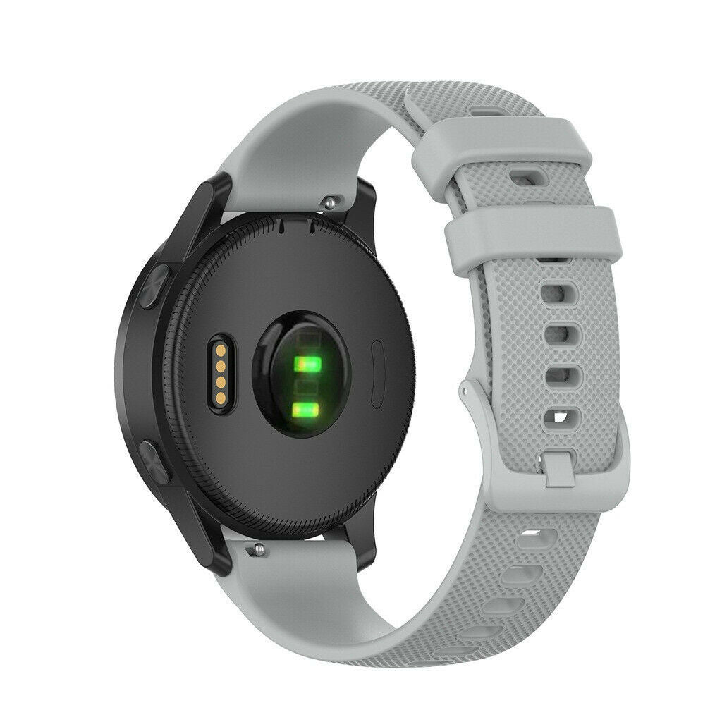 Eine schwarze Smartwatch mit grauem Armband. Die Uhr hat ein rundes Zifferblatt mit grünem Licht. Das Armband hat Löcher.