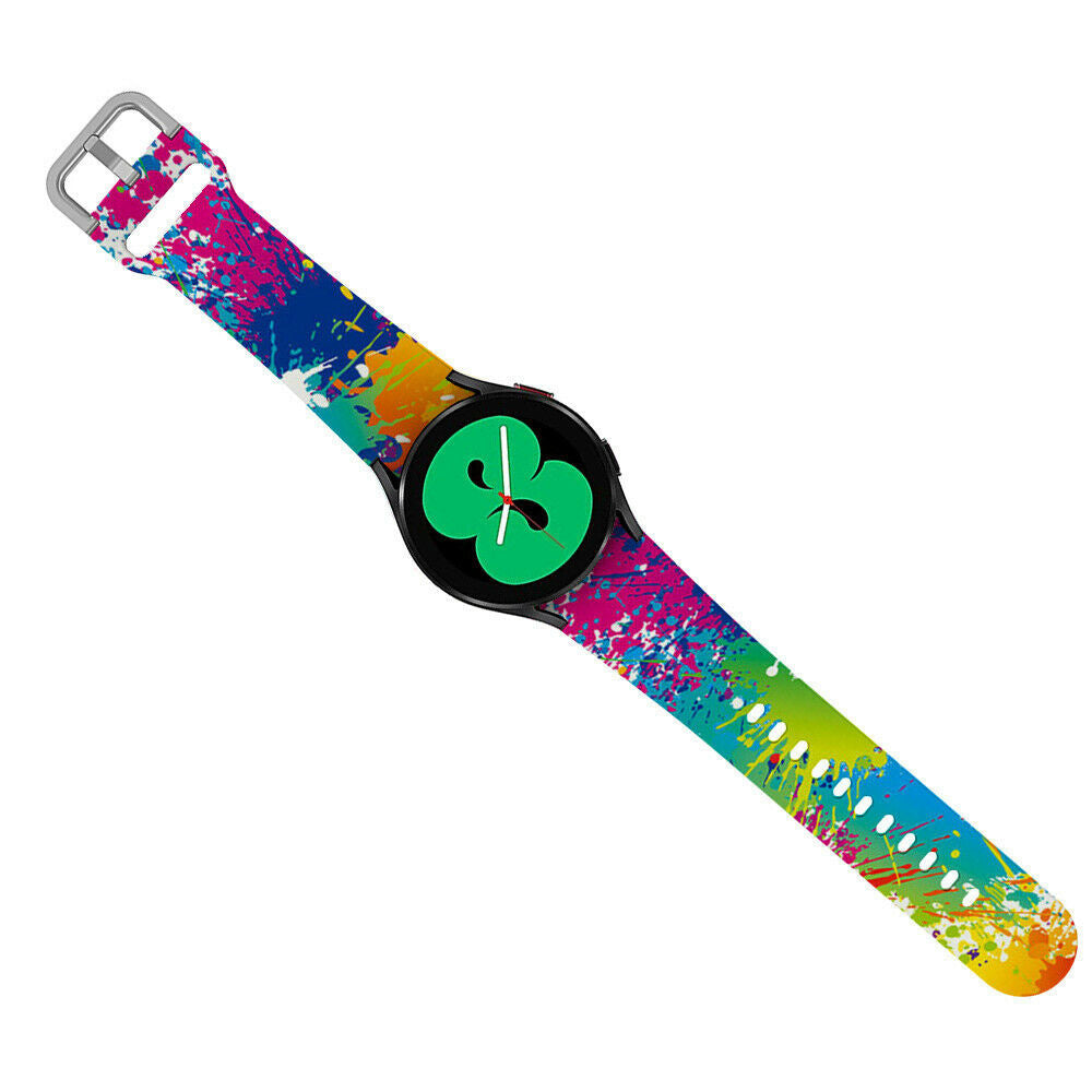 Eine Smartwatch mit buntem Armband, mit Farbspritzern. Das Zifferblatt ist schwarz mit einer grünen Grafik.