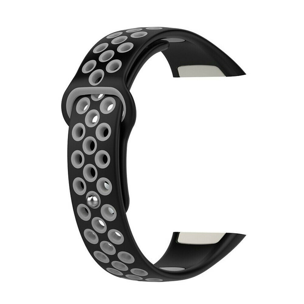 Ein schwarzes und graues Uhrenarmband wird gezeigt. Das Armband hat zahlreiche kleine runde Löcher. Der Hintergrund ist weiß.