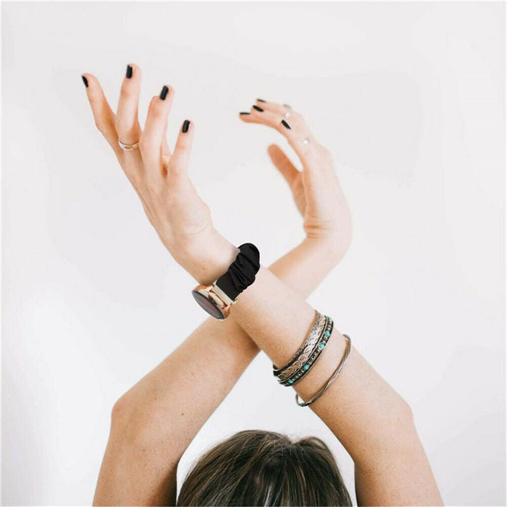 Arme der Frau gekreuzt, Hände hoch. Schwarzer Nagellack, Ringe, Uhr und Armbänder. Weißer Hintergrund.