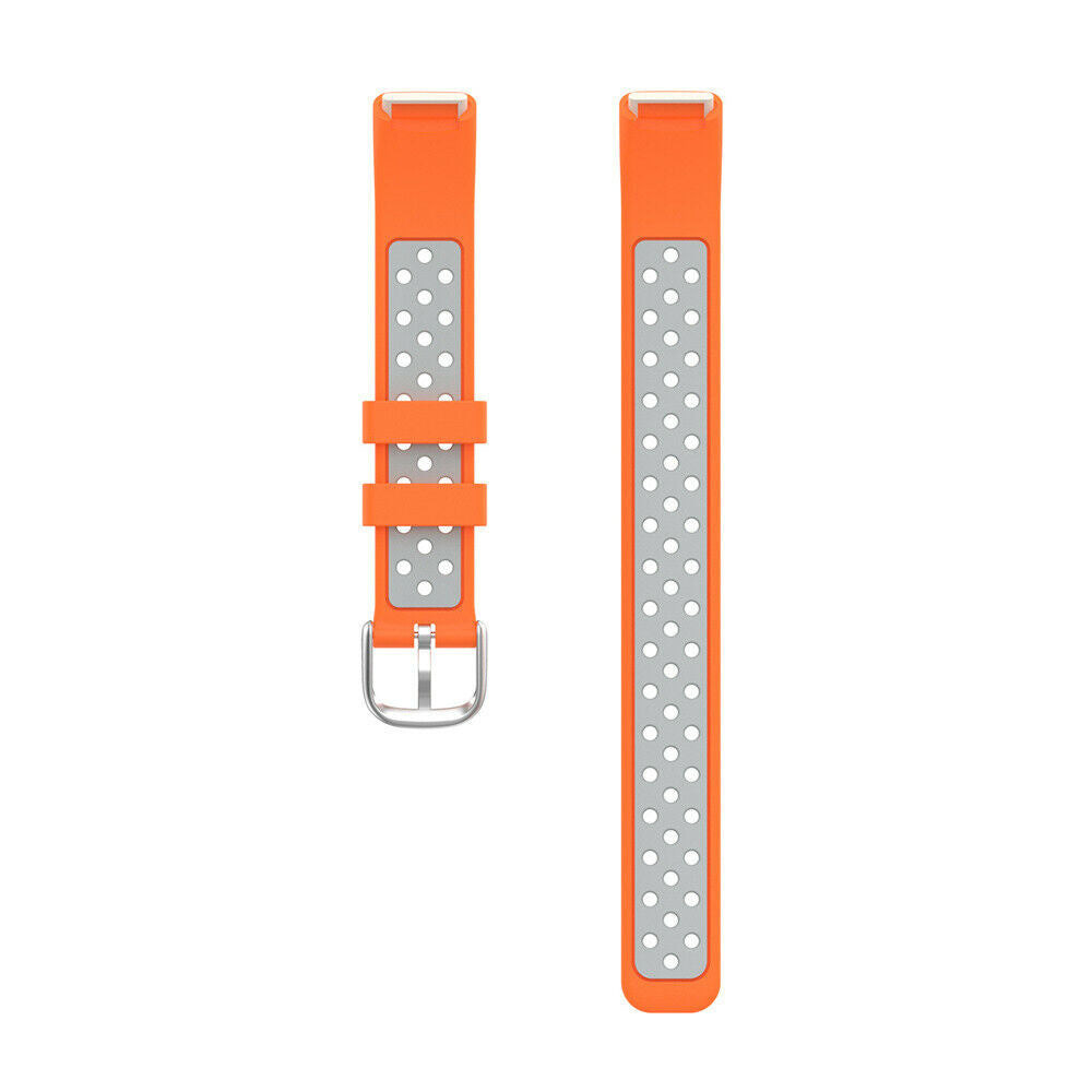 Zwei orangefarbene Uhrenarmbänder. Eines hat eine silberne Schnalle. Beide haben graue Abschnitte mit weißen Punktmustern und weiße Enden.