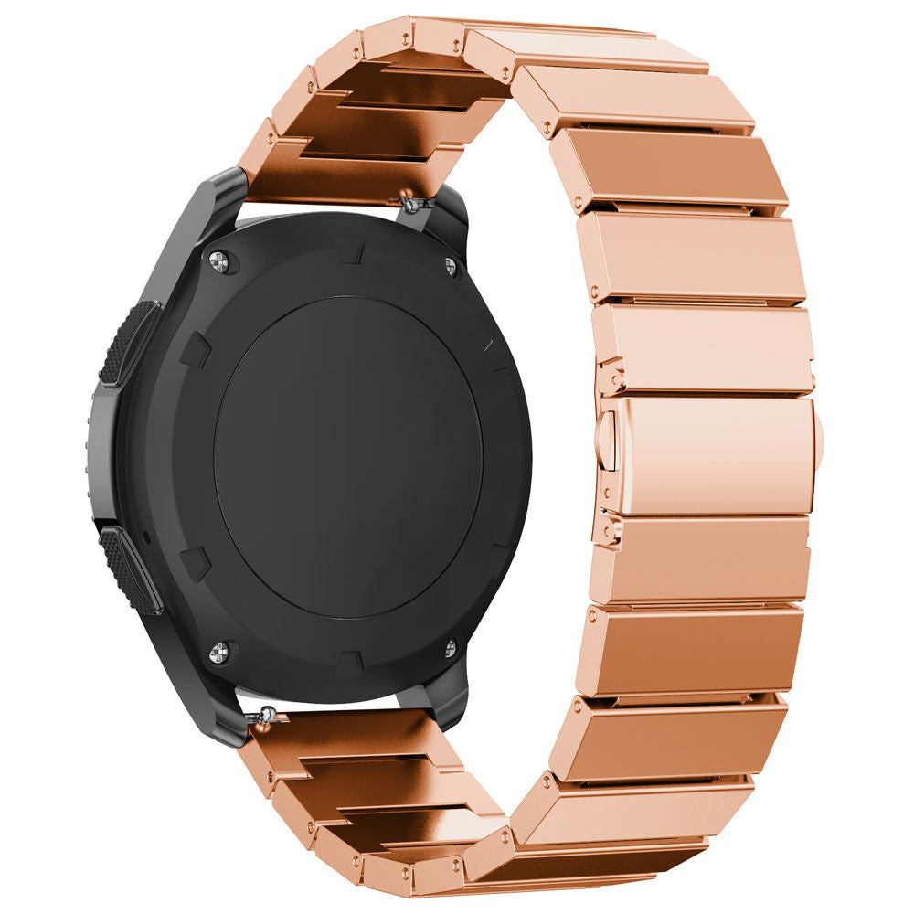 Eine schwarze Smartwatch mit roségoldenem Metallarmband. Das Armband ist mit der Uhr verbunden, mit einem Verschluss. Die Uhr hat ein rundes Display.