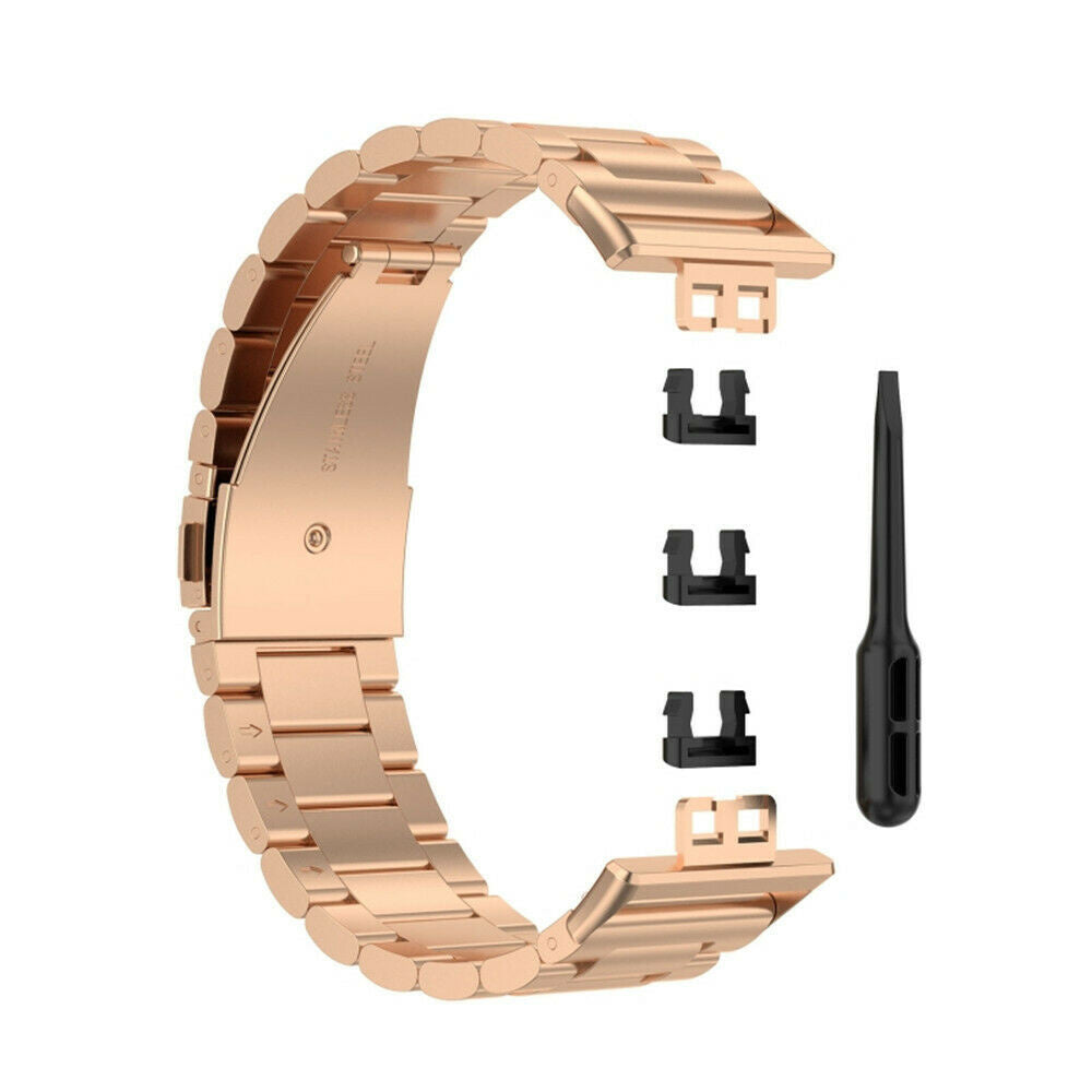 Roségoldenes Uhrenarmband mit drei schwarzen Steckern und einem schwarzen Werkzeug auf weißem Hintergrund. Das Band ist offen.