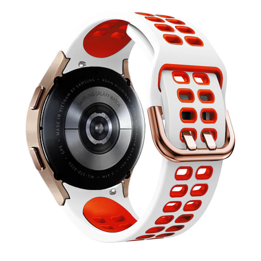 Eine Smartwatch mit weißem und orangefarbenem Armband. Die Uhr hat ein goldfarbenes Gehäuse und einen schwarzen Rücken mit Text. Das Armband ist weiß mit orangefarbenen Akzenten.