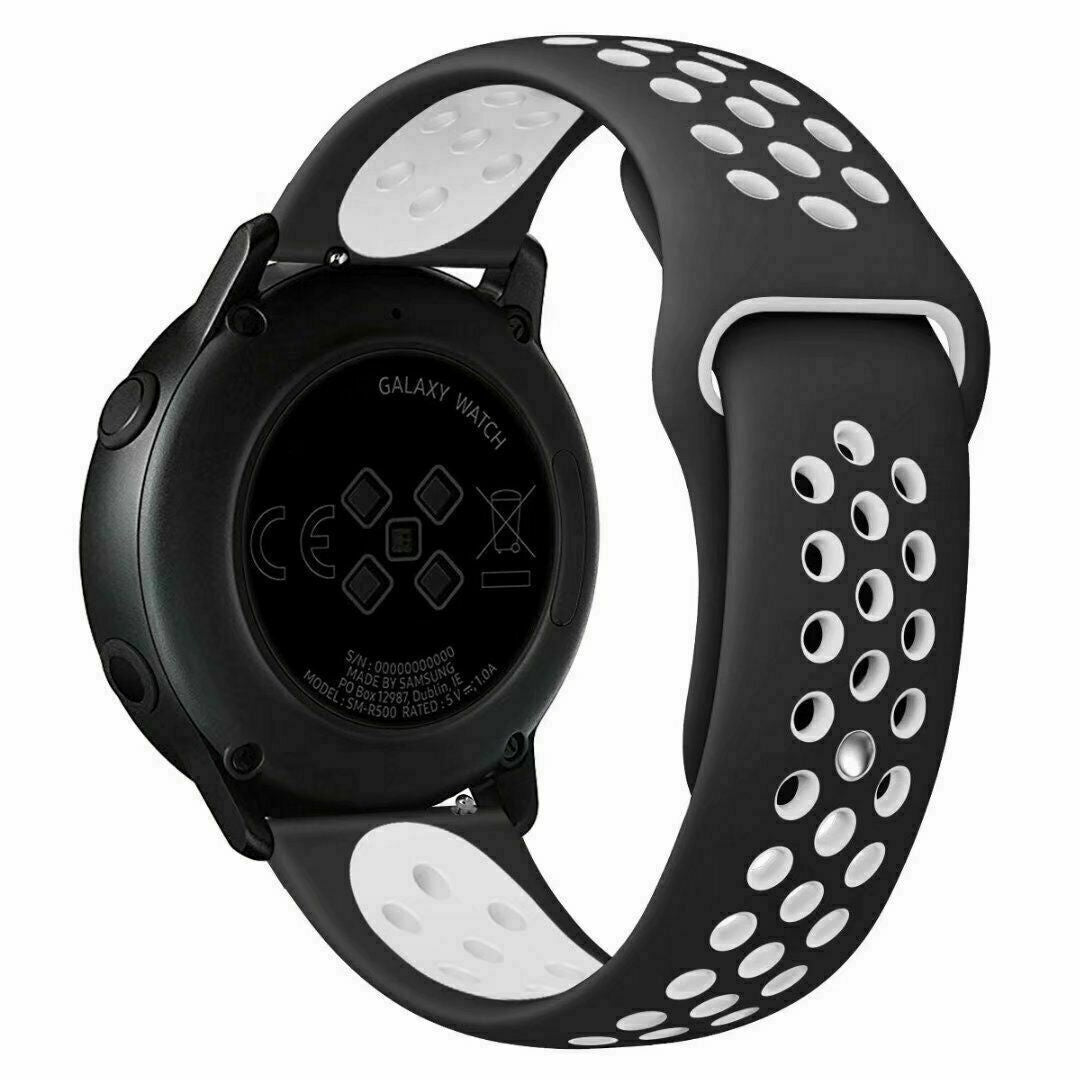 Schwarze Galaxy Watch mit schwarz-weißem Armband. Zifferblatt sichtbar, zeigt Text und Symbole. Armband hat weiße Löcher.