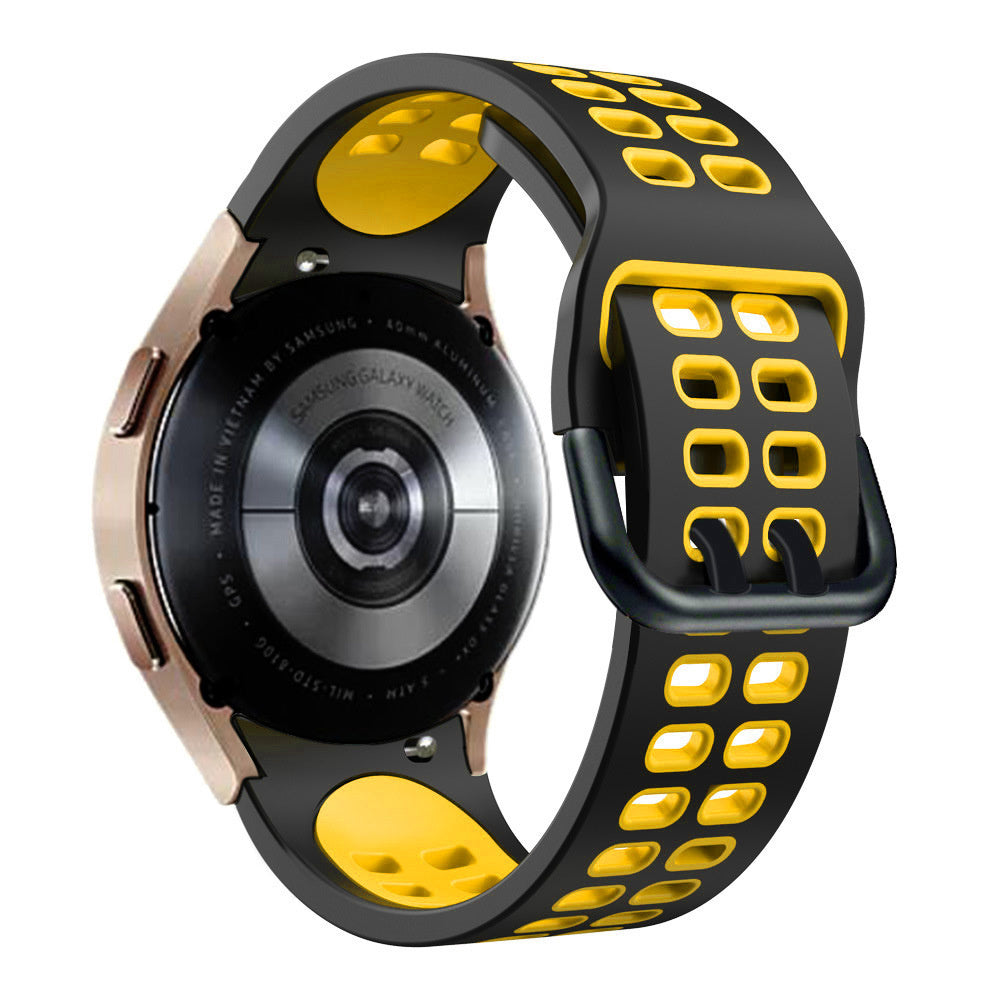 Eine Samsung Galaxy Watch mit einem schwarz-gelben Armband. Die Uhr ist roségoldfarben und hat Text auf der Rückseite.