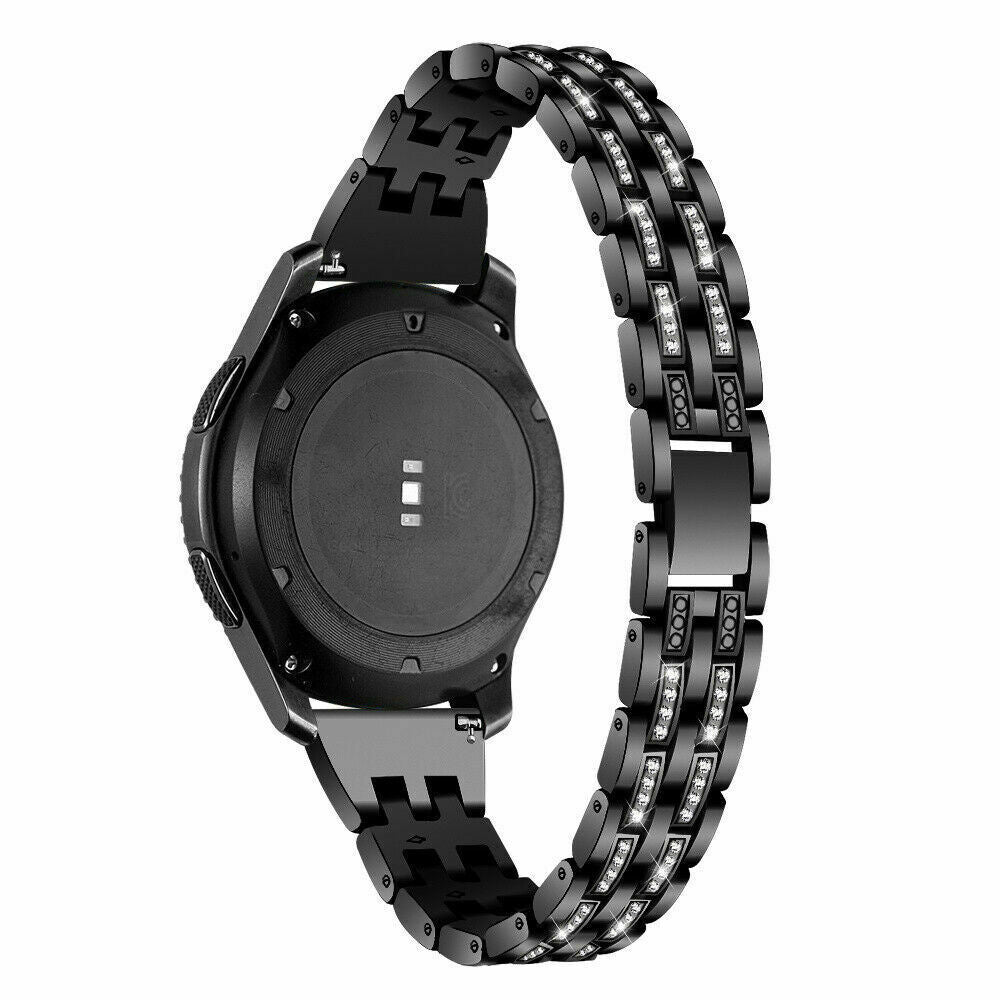Eine schwarze Smartwatch mit einem schwarzen Armband, das mit glitzernden Kristallen verziert ist. Die Uhr befindet sich auf weißem Hintergrund. Das Band ist abgenommen.