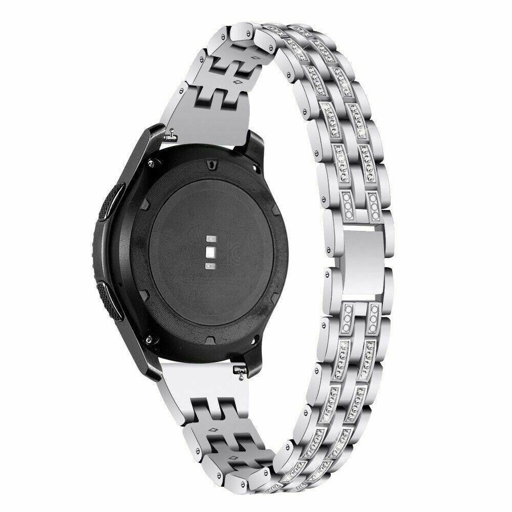 Eine silberne Smartwatch mit einem funkelnden Armband. Die Uhr hat ein schwarzes Zifferblatt und eine Rückseite mit Sensoren.