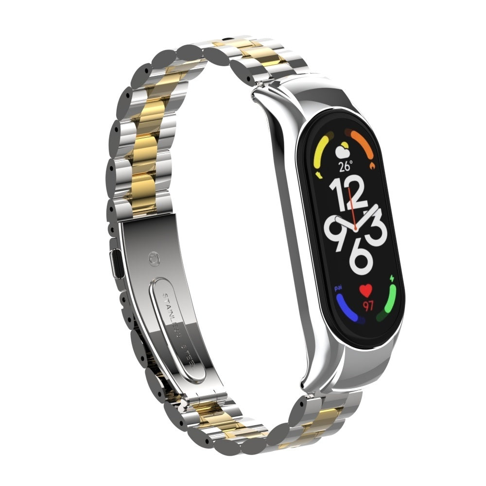 Eine Smartwatch mit silbernem und goldenem Armband. Das Zifferblatt zeigt Uhrzeit, Temperatur und Herzfrequenz. Das Armband ist Edelstahl.