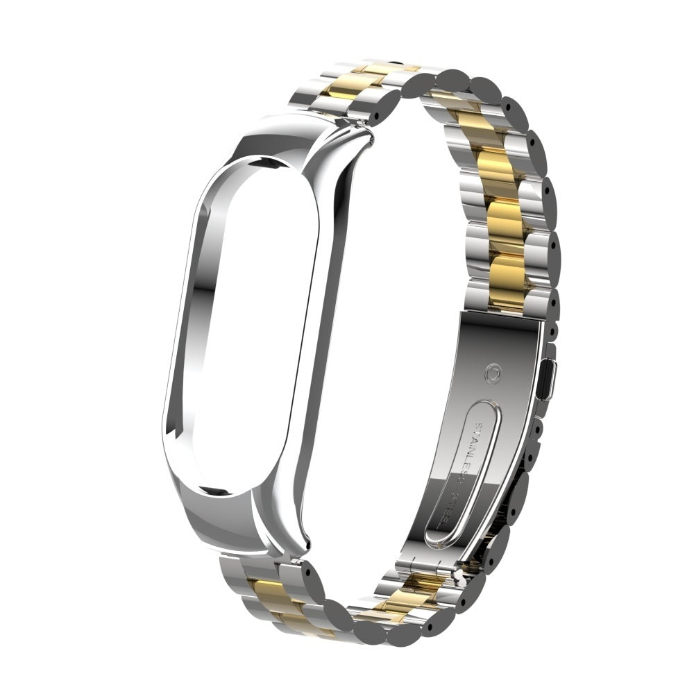 Ein silbernes und goldenes Uhrenarmband. Das Armband besteht aus Metallgliedern. Der Verschluss ist mit Edelstahl beschriftet.