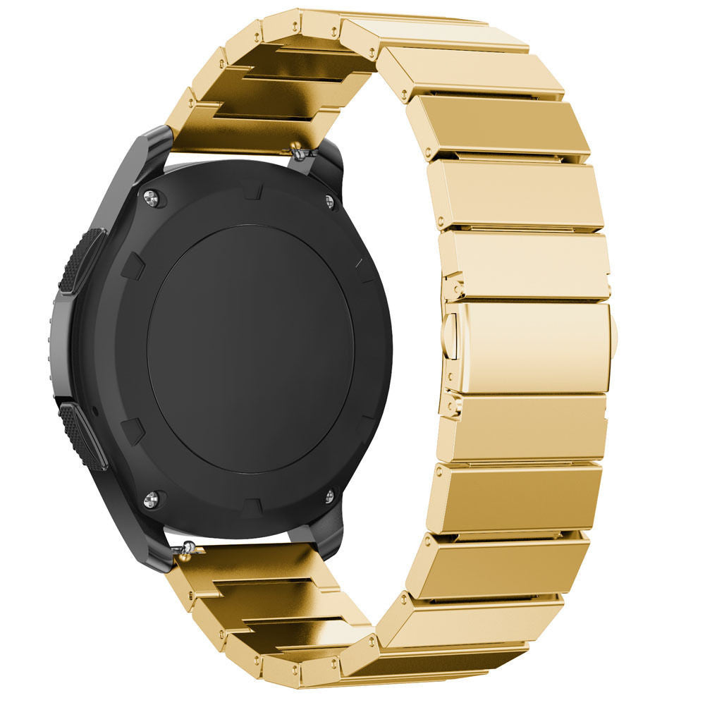 Eine schwarze Smartwatch mit goldenem Metallarmband, teilweise sichtbar. Die Uhr ist abgewinkelt und zeigt die Rückseite und einen Teil des Armbands.