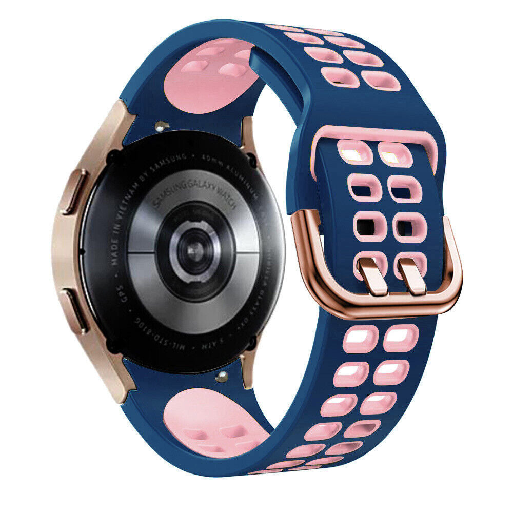 Eine Samsung Galaxy Watch mit blauem und rosa Armband. Die Uhr ist goldfarben. Das Armband hat Löcher. Die Uhr zeigt Text an.