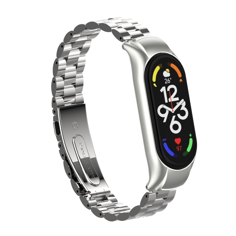 Eine silberne Smartwatch mit Edelstahlband zeigt die Uhrzeit, Herzfrequenz und Temperatur auf einem schwarzen Bildschirm an.