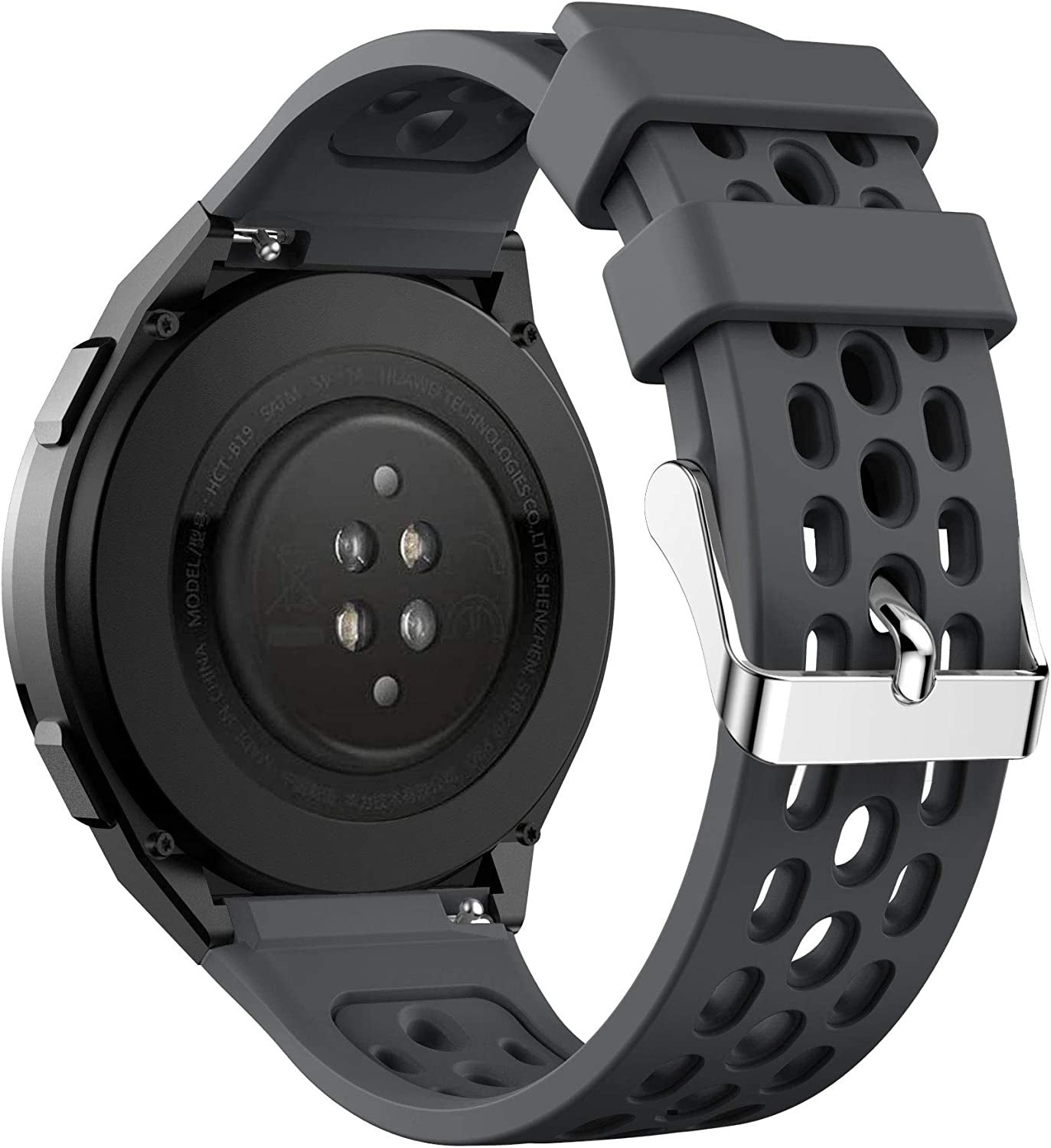 Nahaufnahme einer schwarzen Smartwatch mit grauem Armband. Das Armband hat Löcher. Die Uhr liegt auf einer weißen Oberfläche.