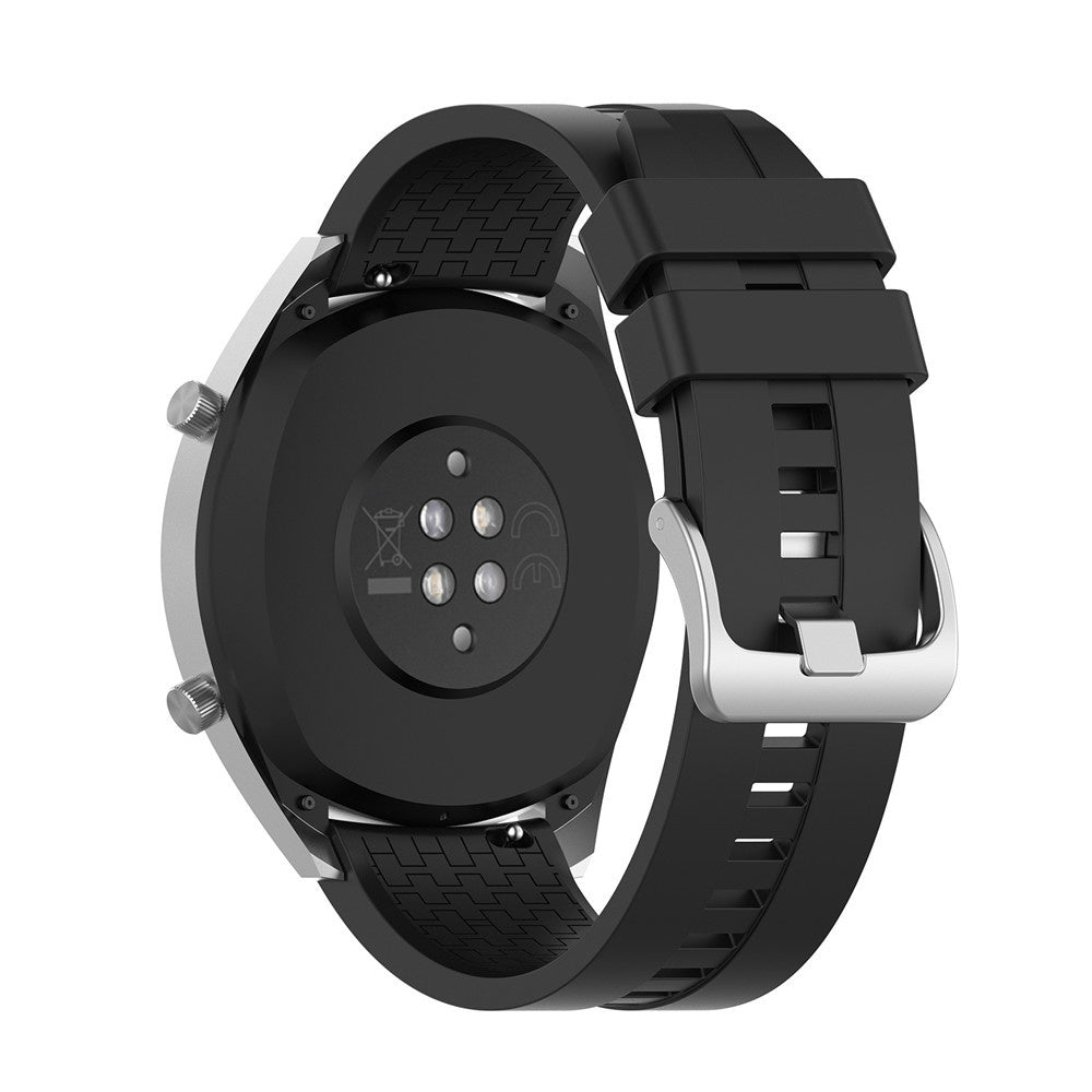 Eine schwarze Smartwatch mit silberner Lünette und schwarzem Armband wird gezeigt. Die Rückseite der Uhr hat Sensoren. Das Armband hat eine silberne Schließe.