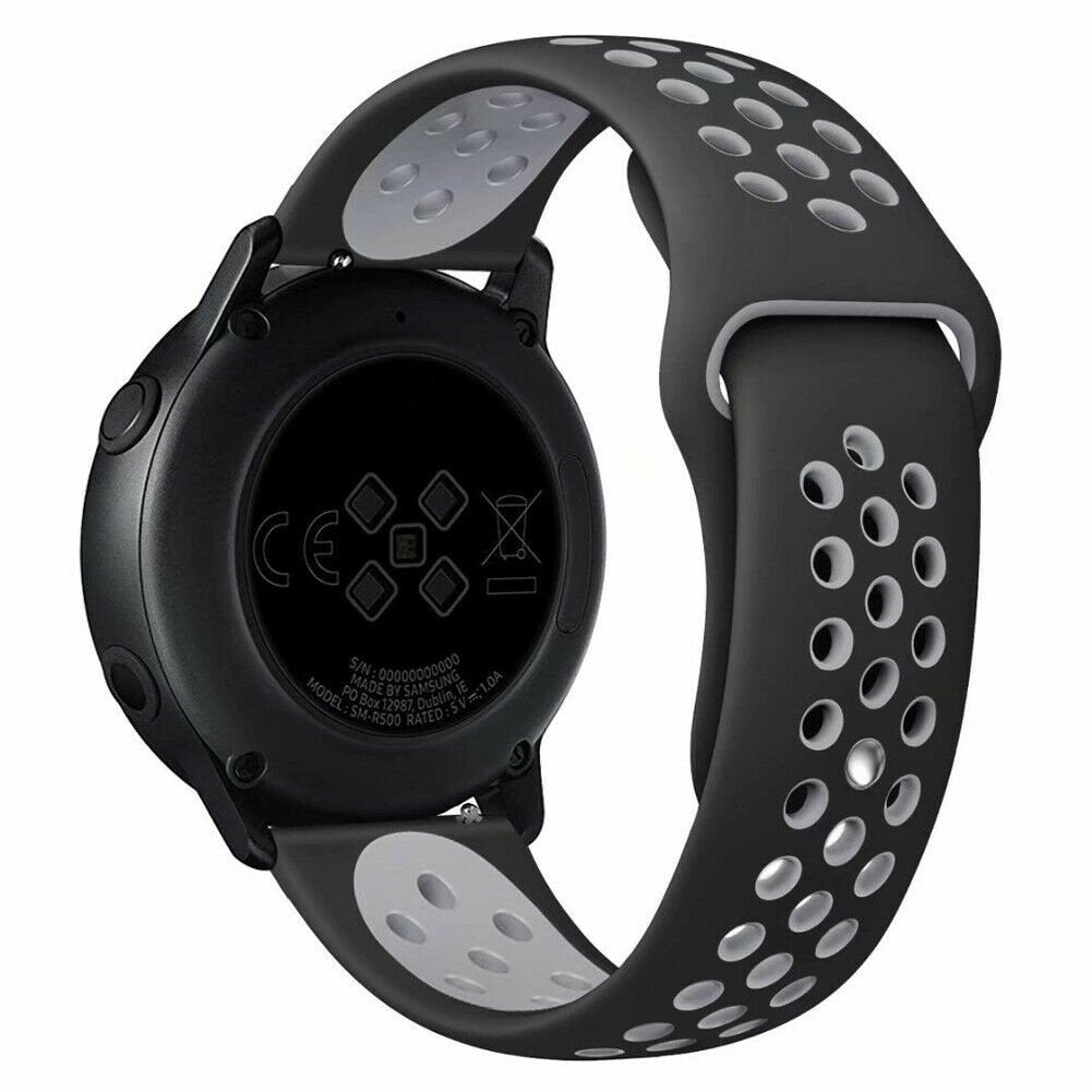 Schwarze Smartwatch mit perforiertem schwarz-grauem Armband. Auf der Rückseite befinden sich ein CE-Zeichen und weitere Details.
