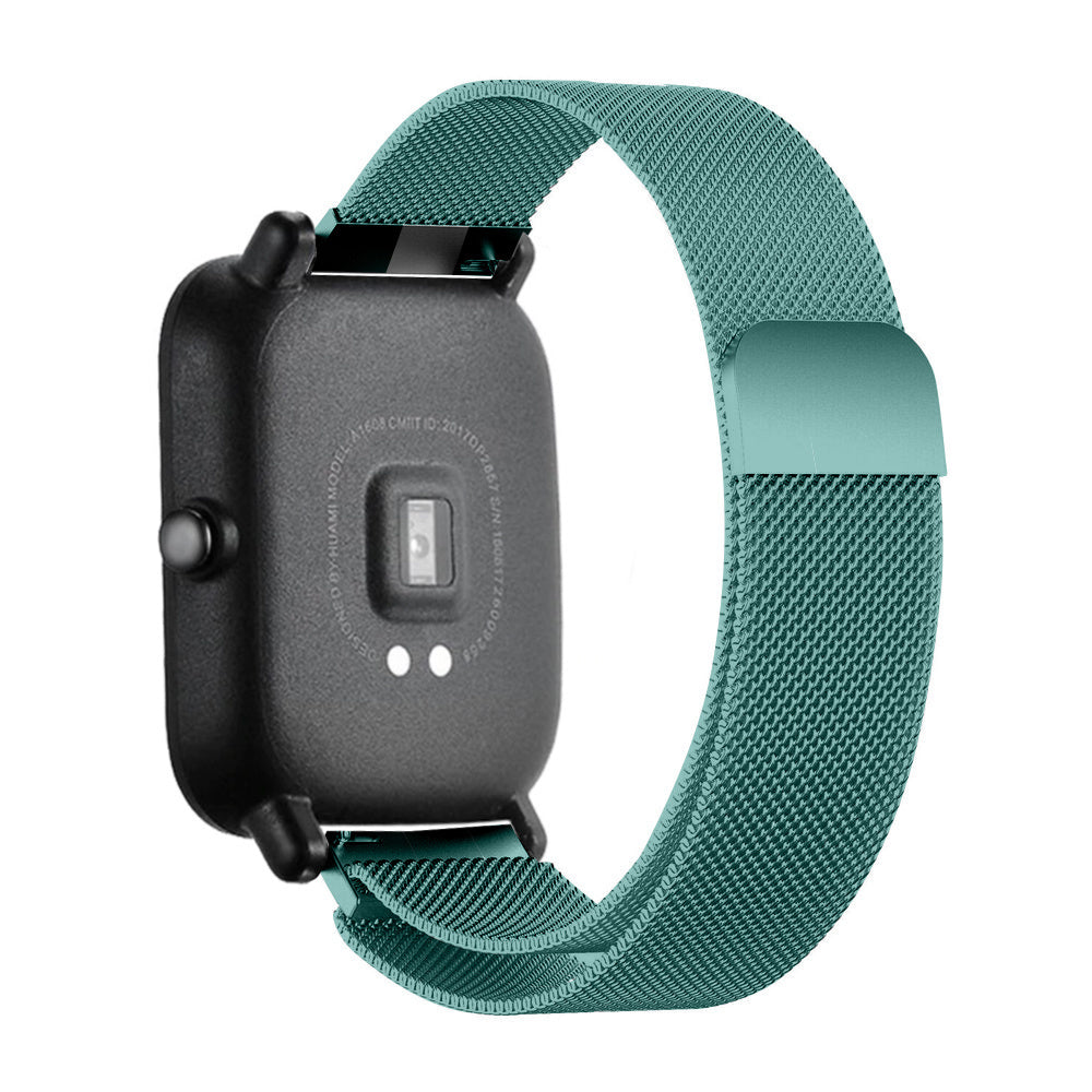 Eine tealfarbene Smartwatch mit passendem magnetischen Mesh-Armband wird vor weißem Hintergrund gezeigt. Die Uhr ist schwarz.