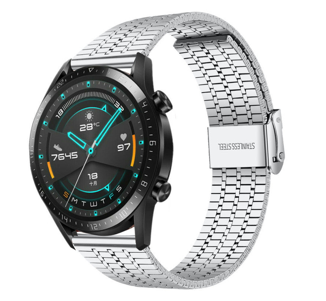 Eine schwarze Smartwatch mit silbernem Armband. Die Uhr zeigt Zeit, Temperatur und Gesundheitsdaten an. Auf dem Armband steht 'STAINLESS STEEL'.