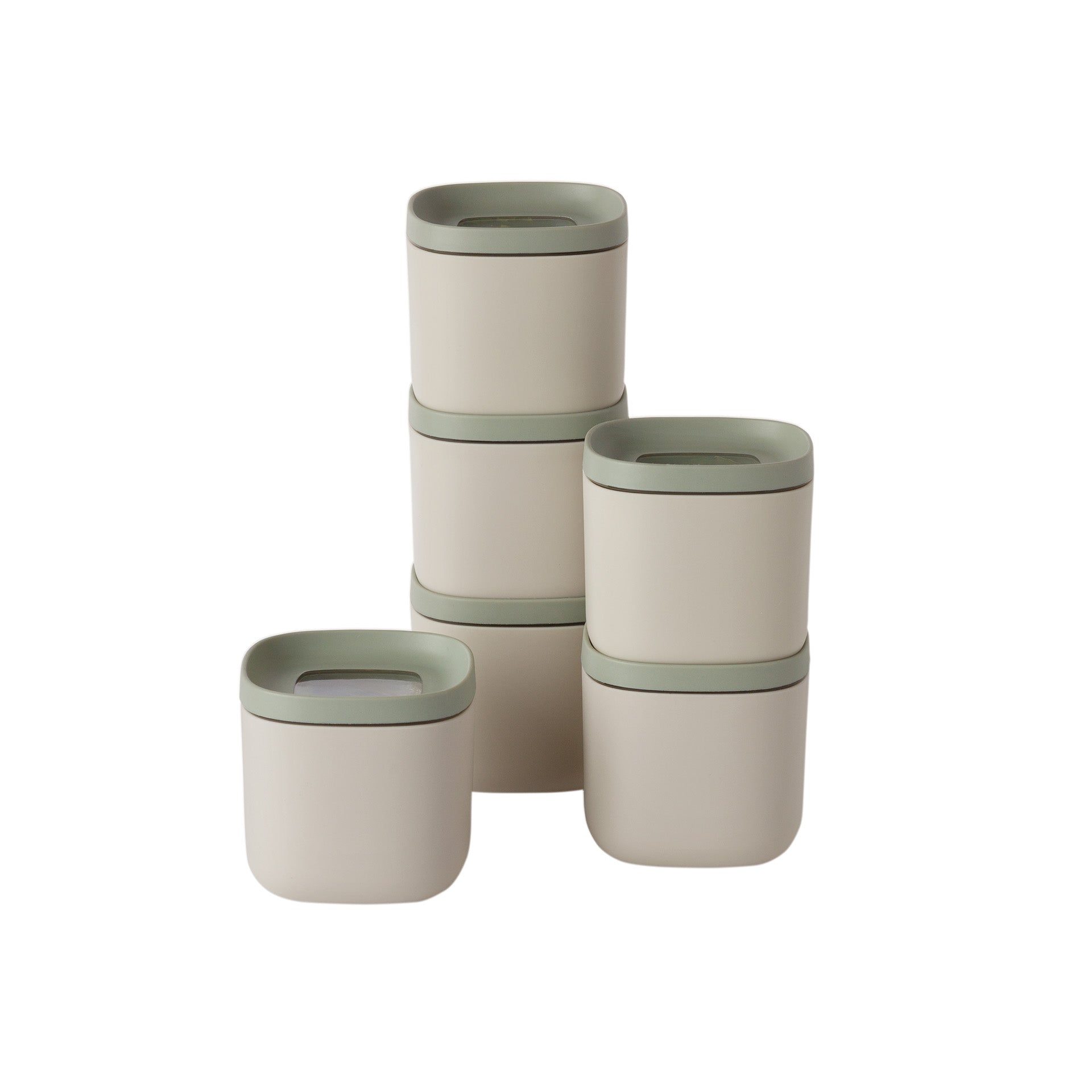 Several beige containers with green lids are stacked. Some are in a tower, others are separate. White background.
