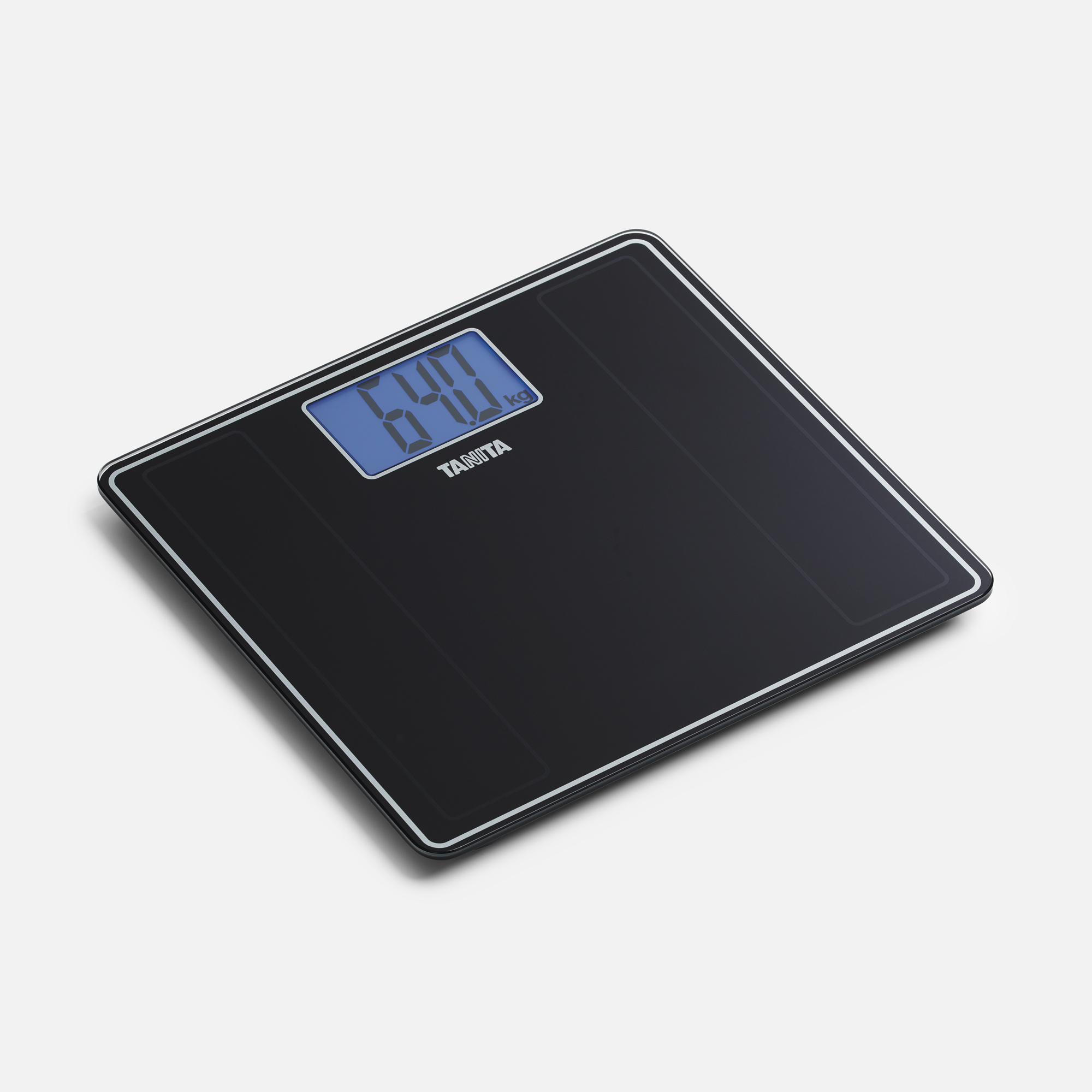 A black digital bathroom scale displays 64.0 kg. It has a blue display and the brand name Tanita is visible.
