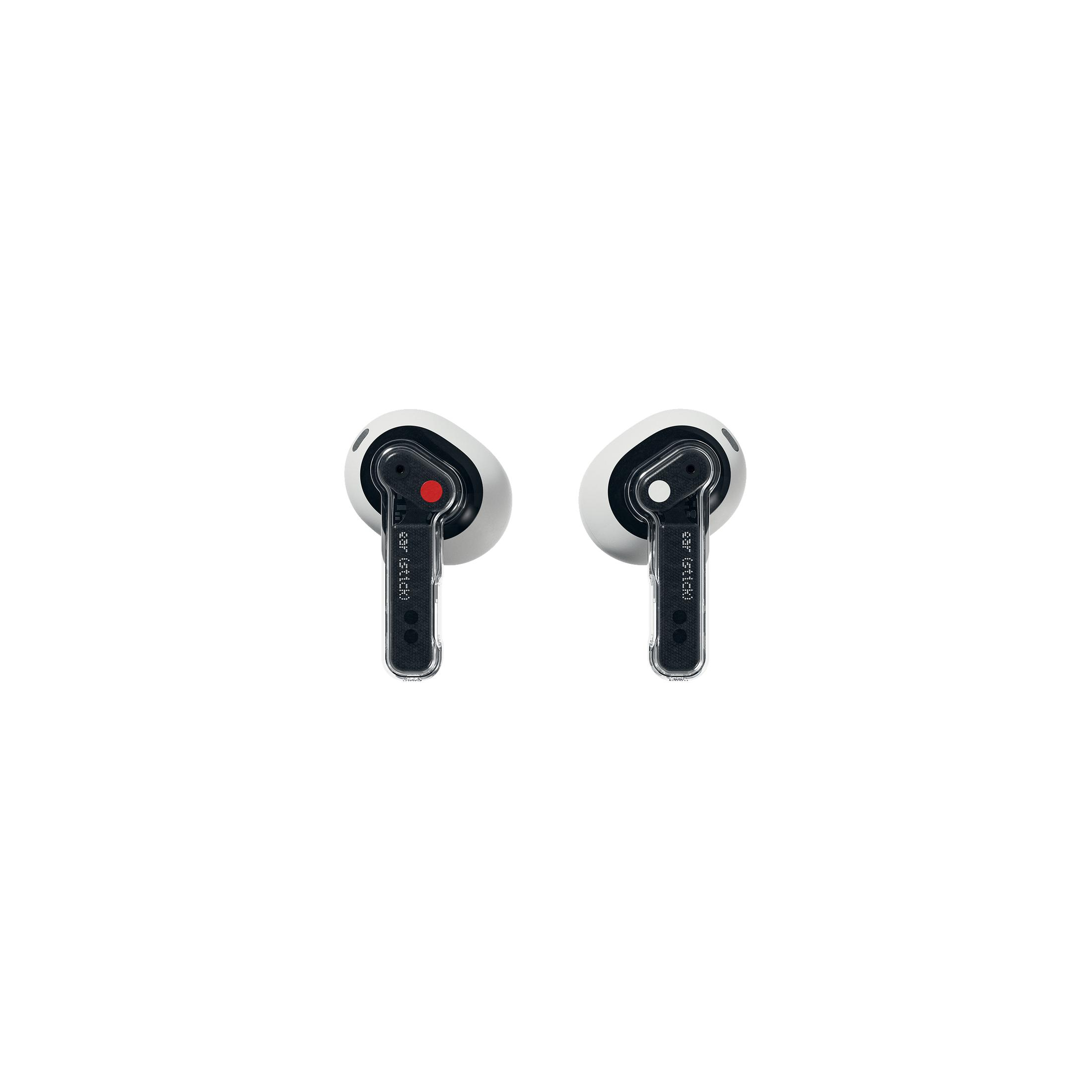 Dos auriculares blancos y negros aislados sobre fondo blanco. Uno tiene un punto rojo, el otro un punto blanco.