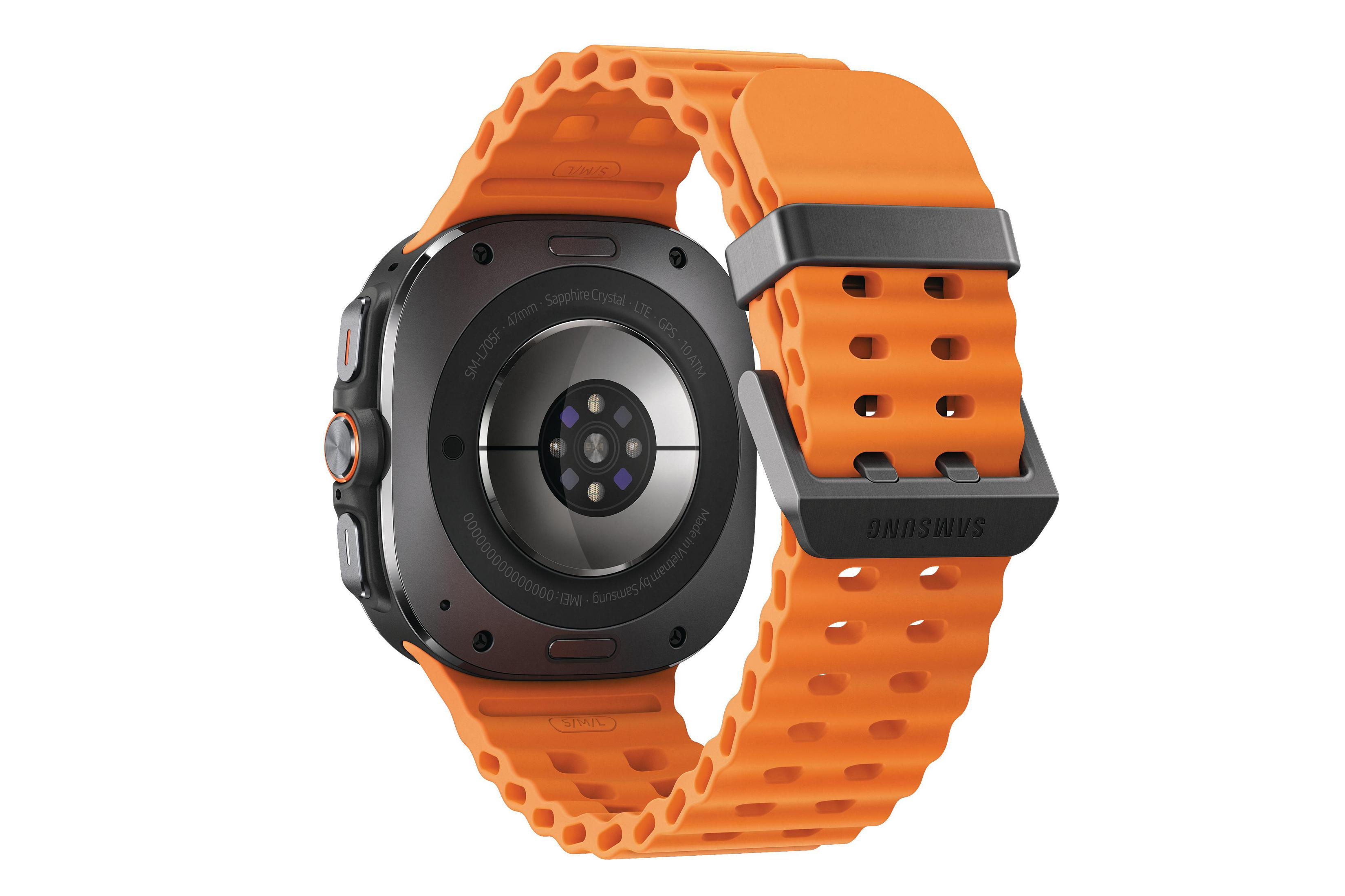 Smartwatch Samsung z pomarańczowym paskiem. Zegarek jest czarny i ma okrągłą tarczę.