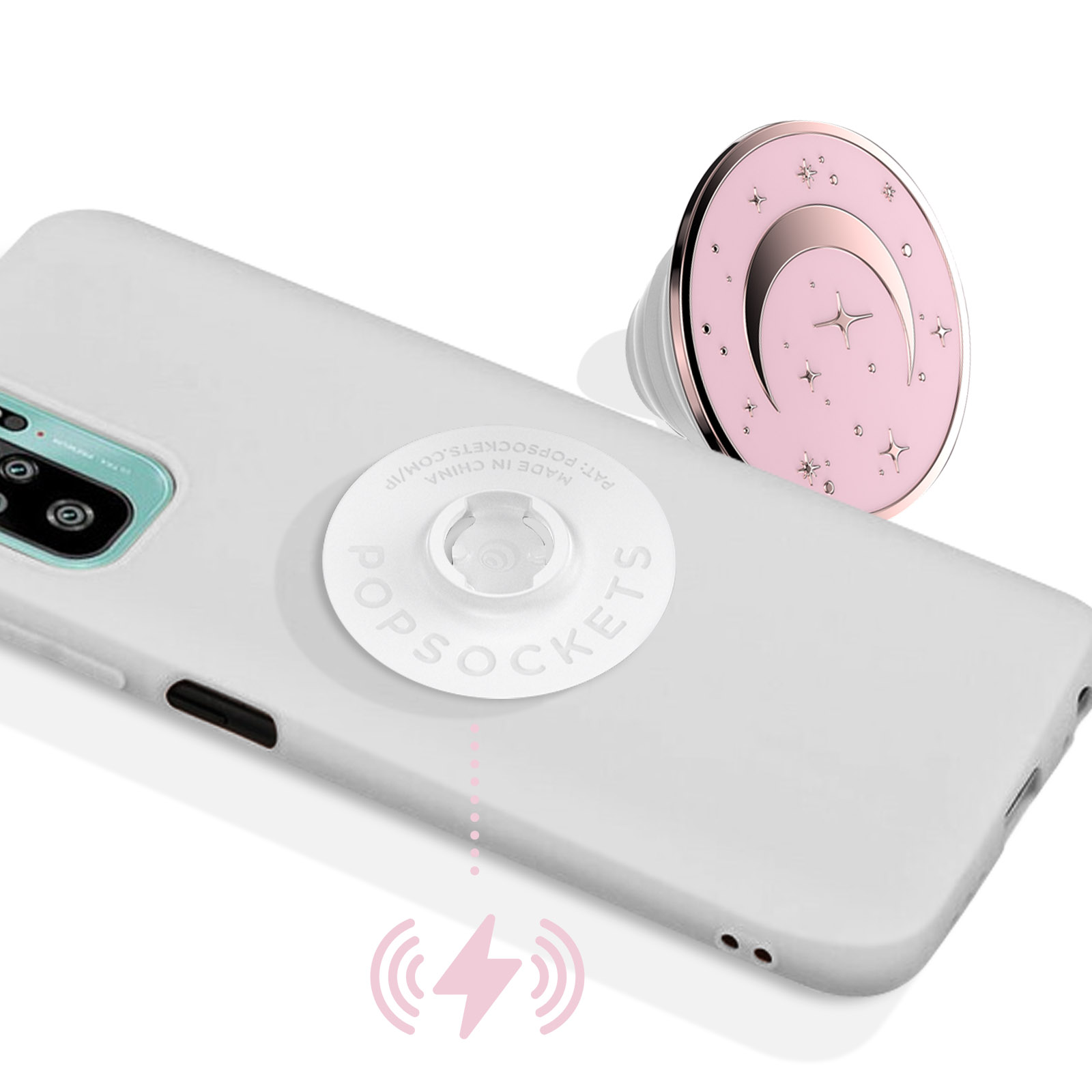 Ein weißes Telefon mit einem rosa Popsocket mit Mond- und Sterndesign und einem Bild eines drahtlosen Ladesymbols.