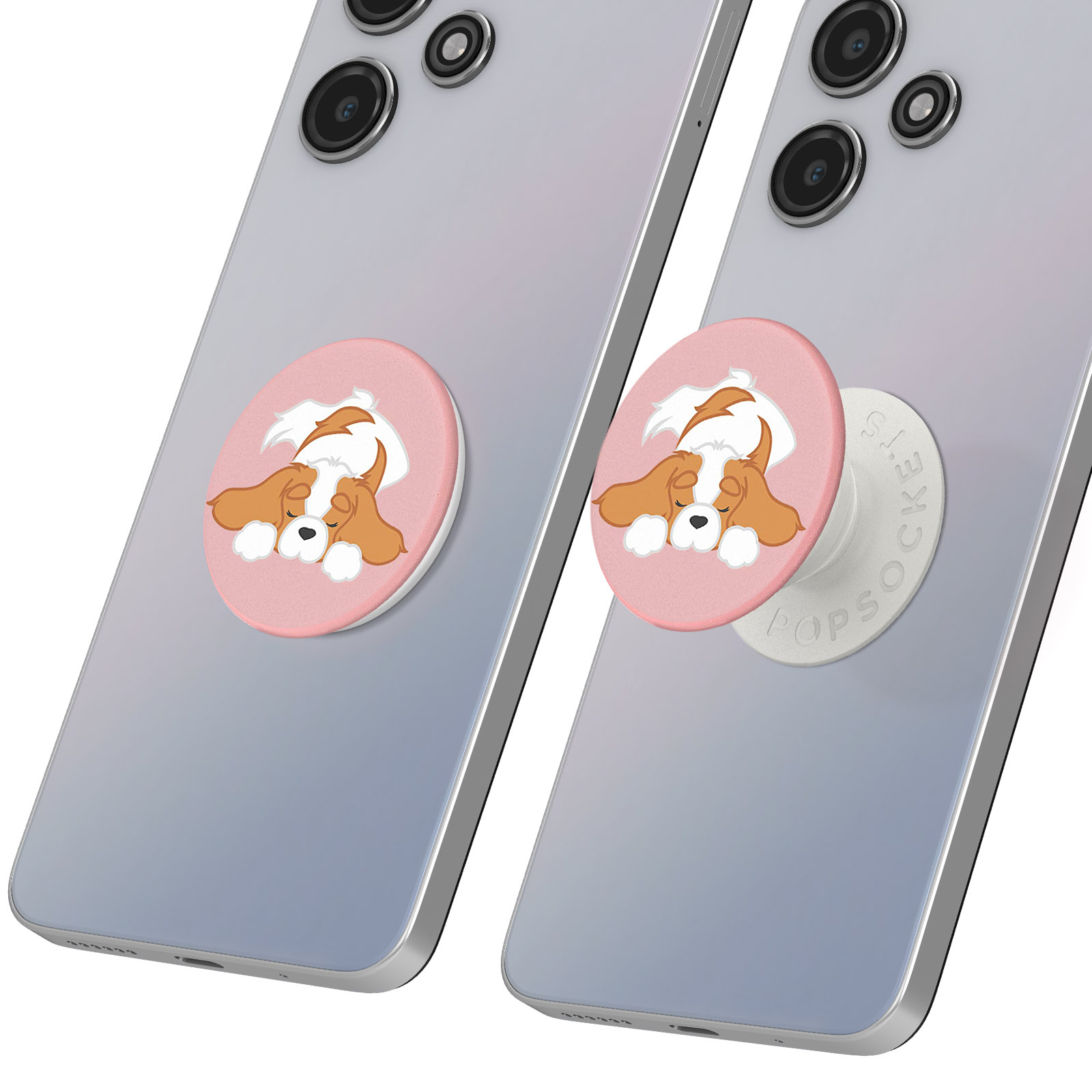 Due telefoni con PopSocket a forma di cane. Il cane è marrone, bianco e su sfondo rosa. Una presa è estesa.