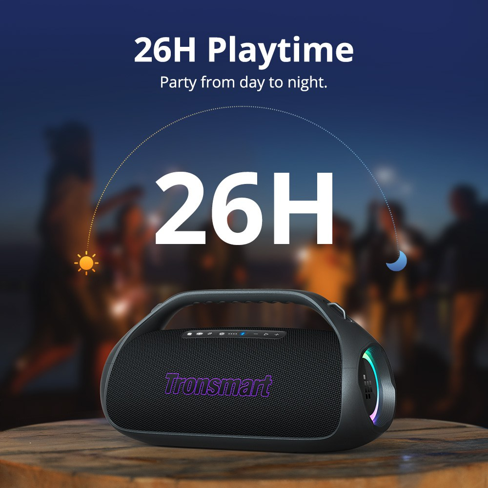 Schwarzer Tronsmart-Lautsprecher auf einem Holztisch. Der Hintergrund zeigt Silhouetten von Menschen. Text lautet 26H Playtime.