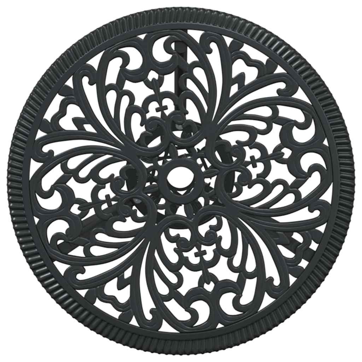 Una mesa redonda negra con un diseño decorativo calado. Tiene un borde con dibujos y un agujero central.