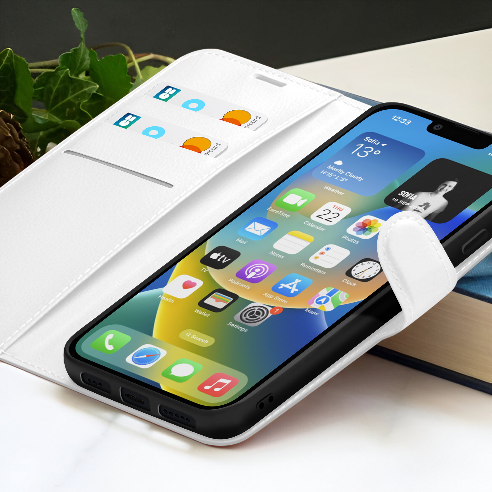 Un iPhone affiche son interface avec icônes et widgets. Il repose dans un étui blanc avec des fentes pour cartes.