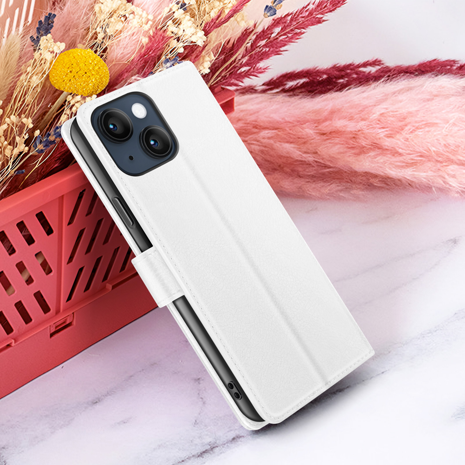 Étui de téléphone blanc avec téléphone à l'intérieur, contre des fleurs décoratives et du marbre. L'étui a une fermeture magnétique.