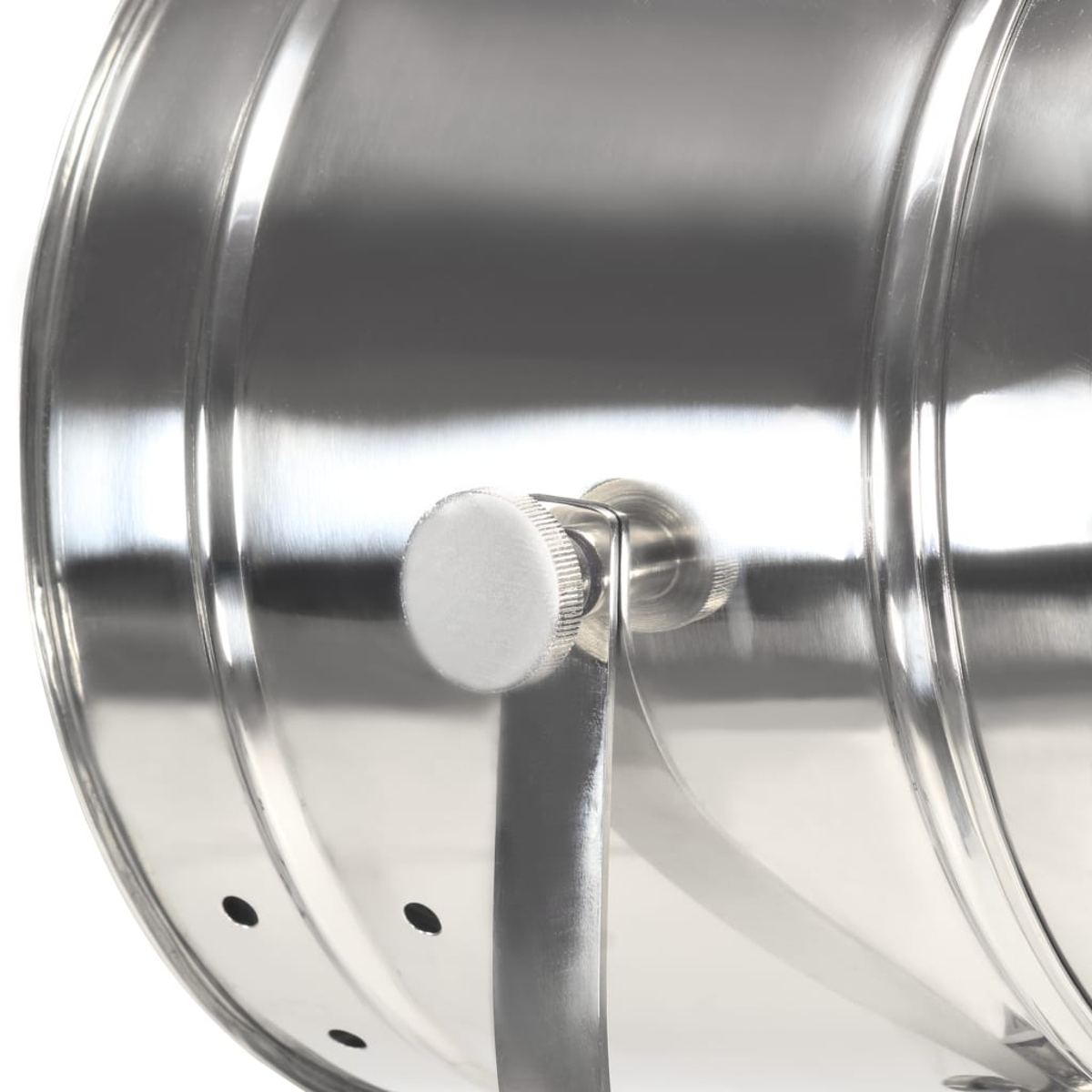 Nahaufnahme einer glänzenden Metalltrommel mit weißem Knopf und Metallgriff. Die Trommel hat eine Reihe kleiner schwarzer Löcher.